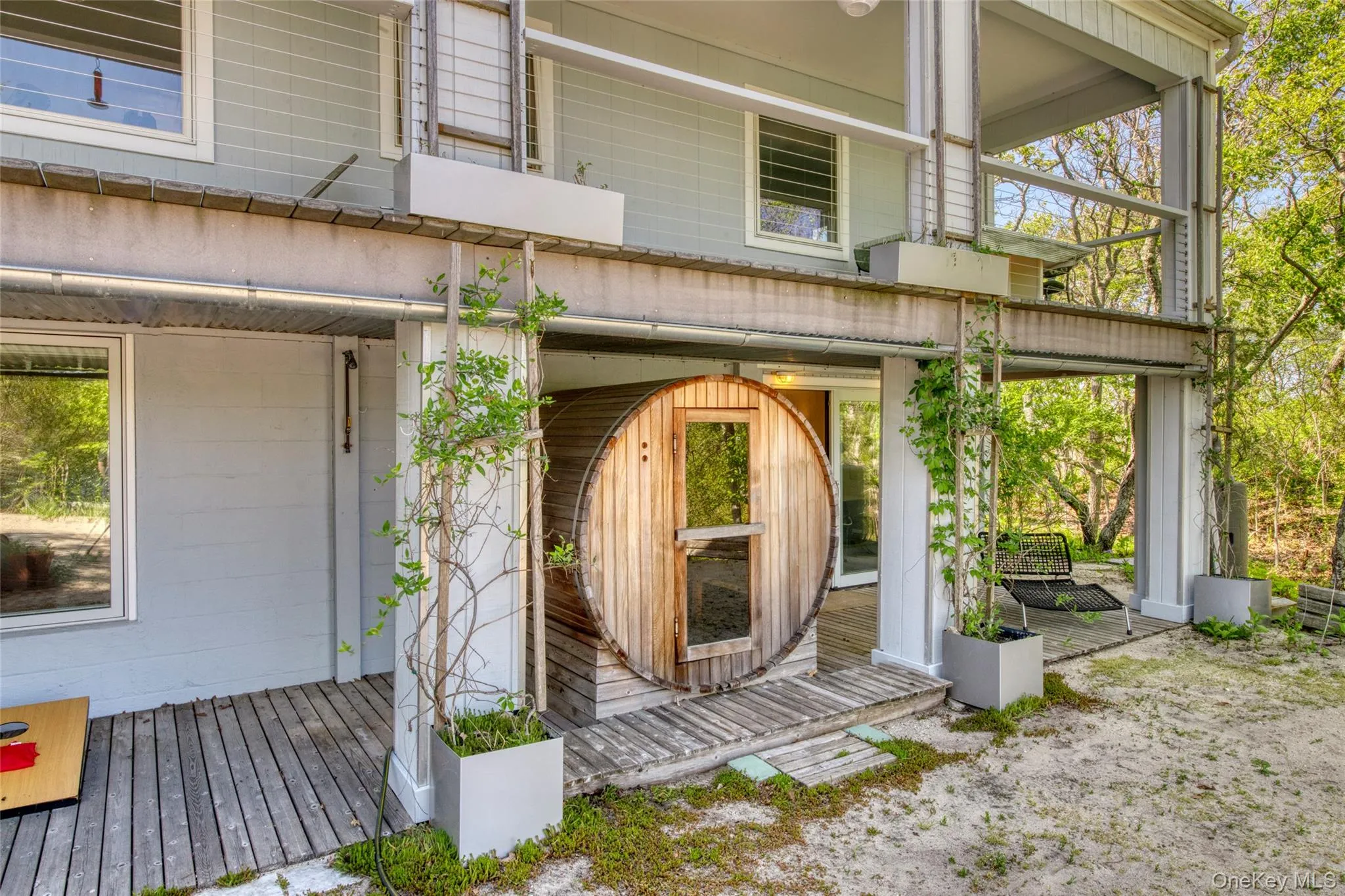 Garden level deck with water view, sauna, outdoor shower, lounging area Garden level deck with water view, sauna, outdoor shower, lounging area