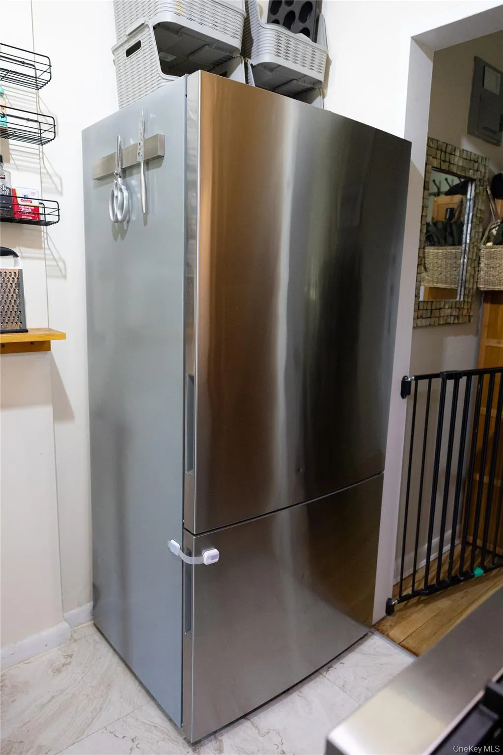 Stainless steel refrigerator featuring a bottom freezer drawer and a top refrigerator compartment Stainless steel refrigerator featuring a bottom freezer drawer and a top refrigerator compartment