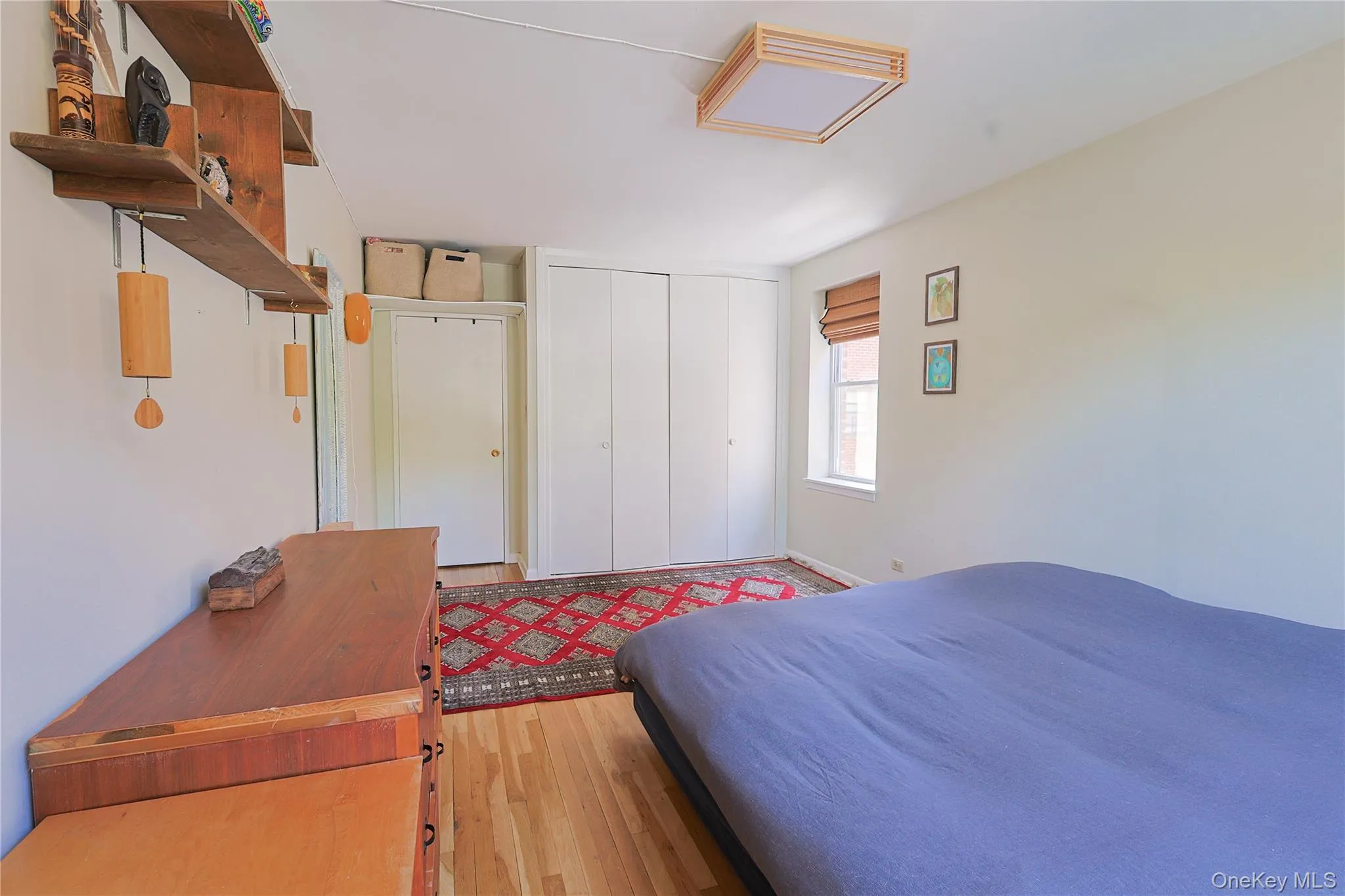 Room with wood-finish flooring, a window Room with wood-finish flooring, a window