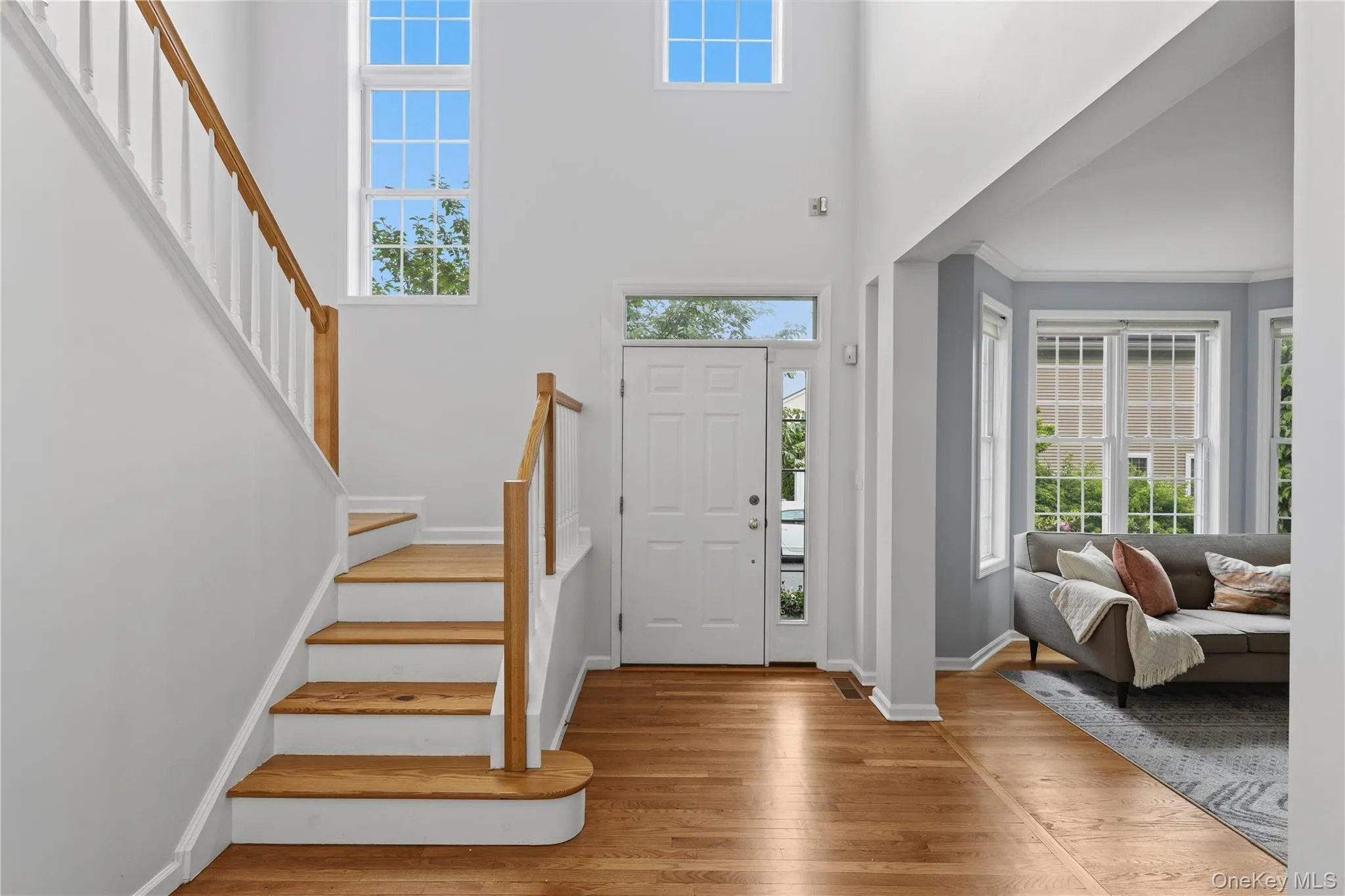 Two-story entryway with wall of windows and beautiful sunlight Two-story entryway with wall of windows and beautiful sunlight