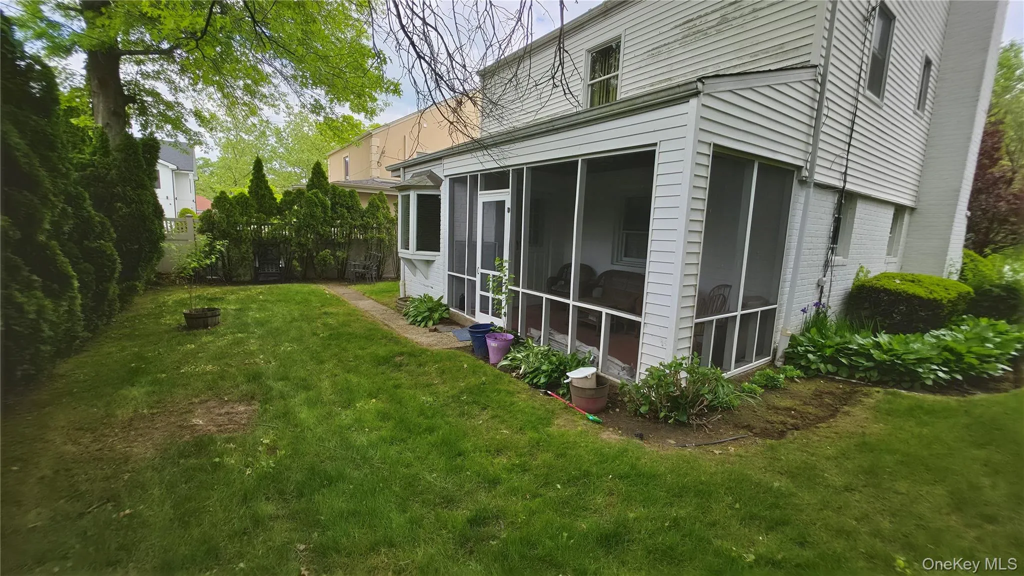 Screened porch with white siding exterior Screened porch with white siding exterior