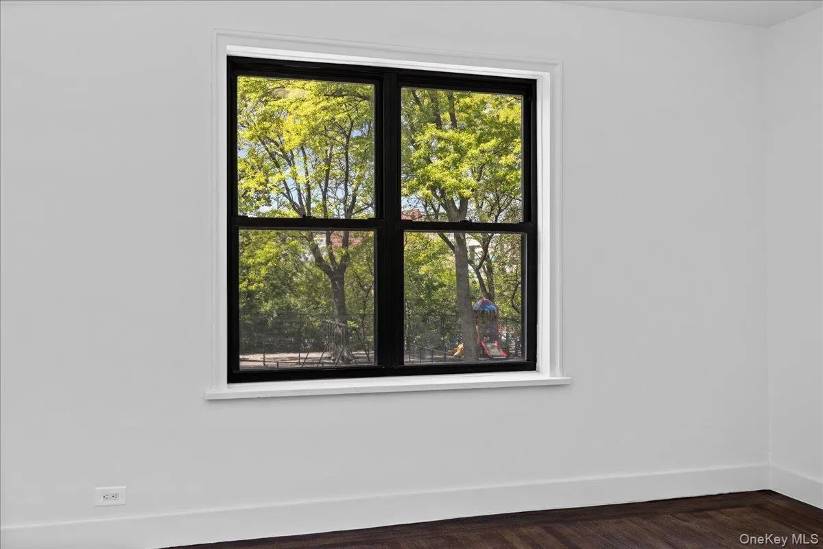 Bright interior space featuring a large window with black framing and white trim Bright interior space featuring a large window with black framing and white trim