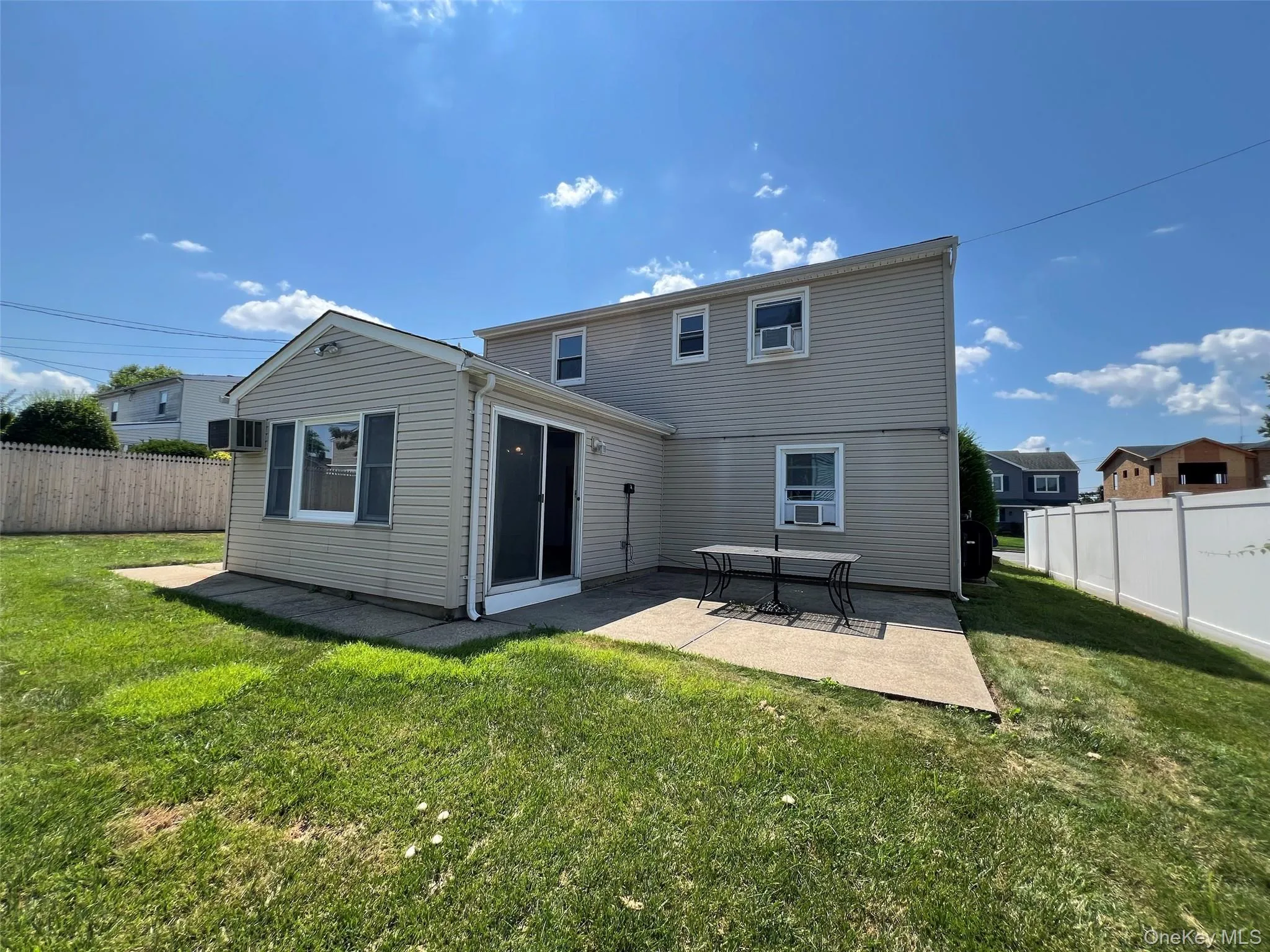 Rear view of property featuring a patio and a fenced backyard Rear view of property featuring a patio and a fenced backyard