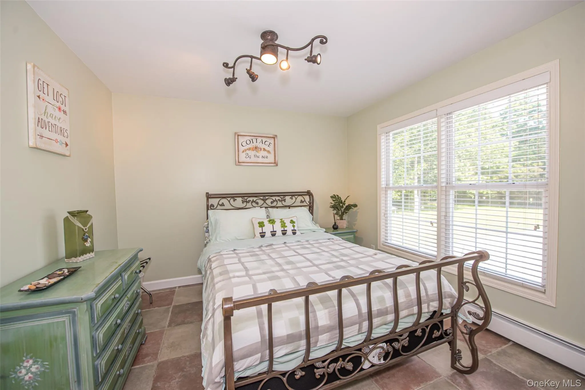 Bedroom featuring a baseboard radiator and baseboards Bedroom featuring a baseboard radiator and baseboards