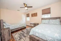 Bedroom with ceiling fan and wood finished floors Bedroom with ceiling fan and wood finished floors