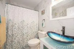 Full bathroom featuring toilet, a shower with curtain, and vanity Full bathroom featuring toilet, a shower with curtain, and vanity