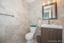 Bathroom featuring toilet and vanity Bathroom featuring toilet and vanity