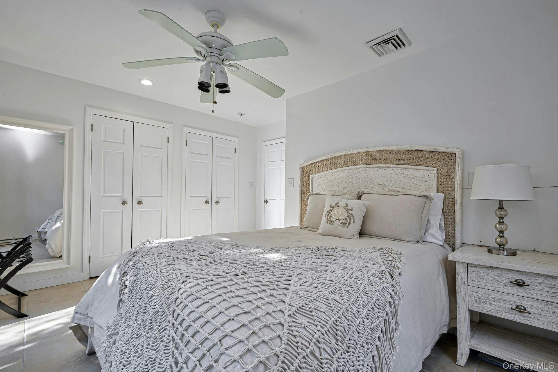 Bedroom featuring a ceiling fan with integrated lighting, multiple paneled closet doors, and recessed lighting Bedroom featuring a ceiling fan with integrated lighting, multiple paneled closet doors, and recessed lighting