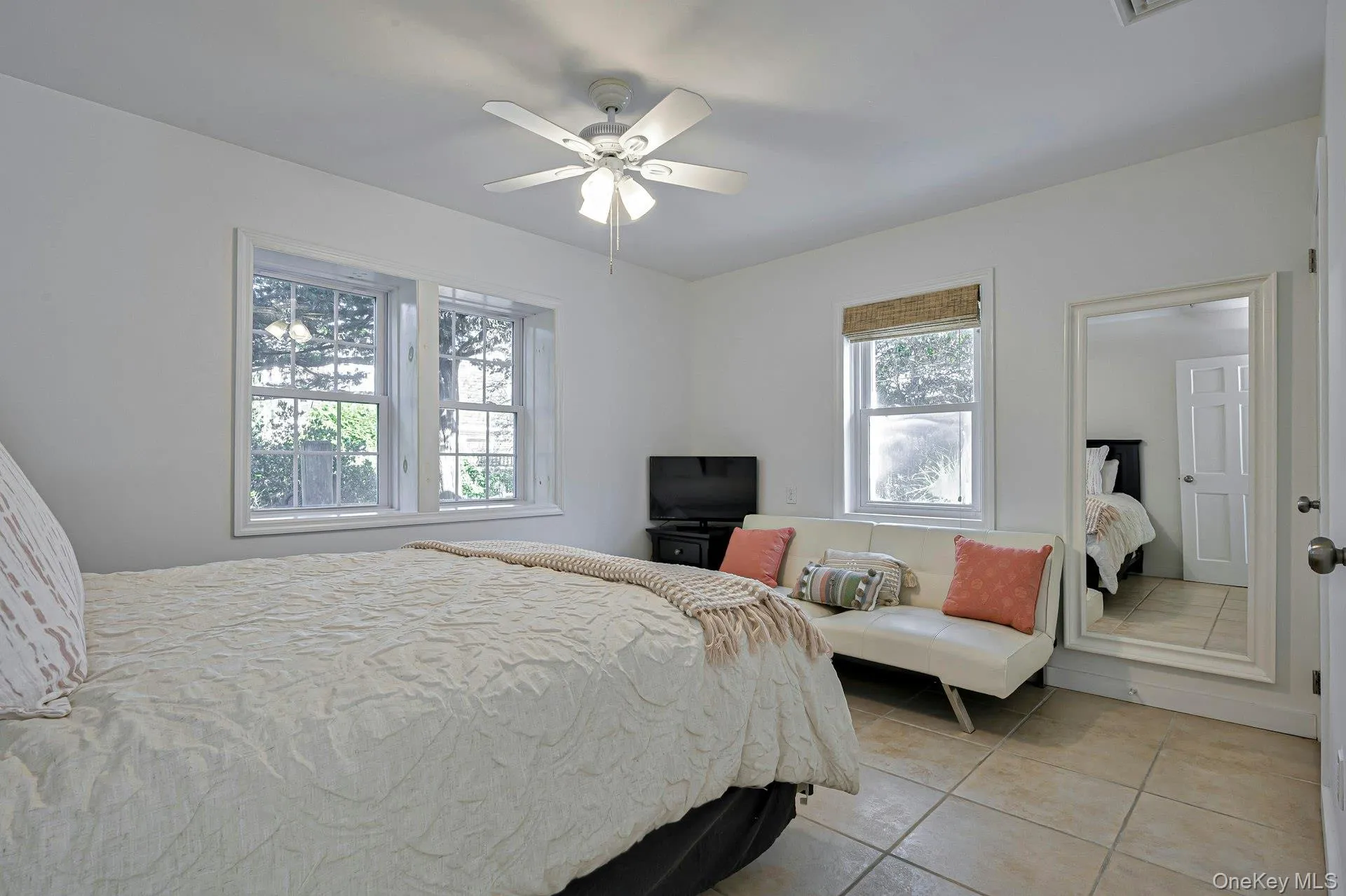 Bright interior featuring tiled flooring and white walls Bright interior featuring tiled flooring and white walls