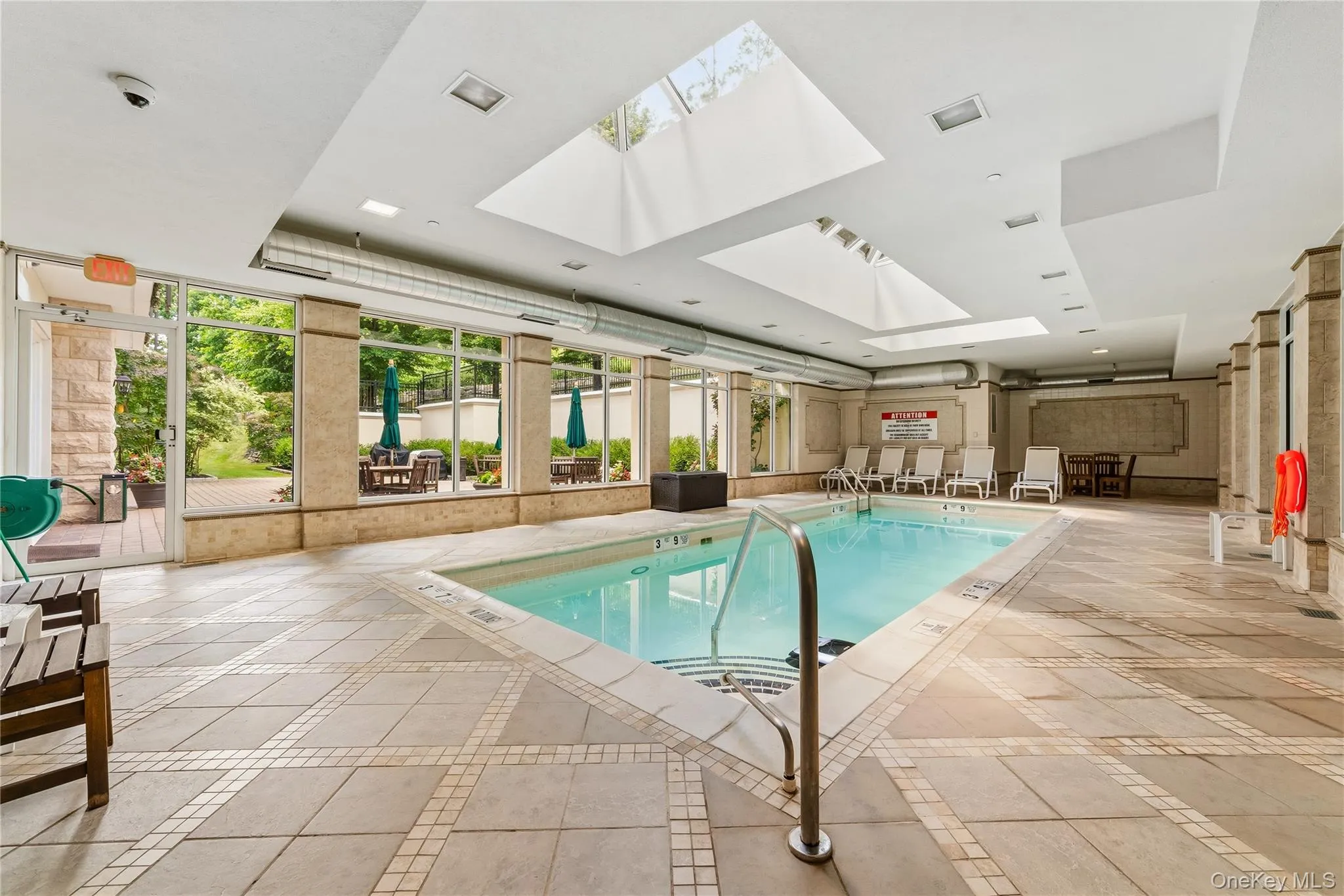 Indoor Pool with floor to ceiling windows located near outdoor space Indoor Pool with floor to ceiling windows located near outdoor space