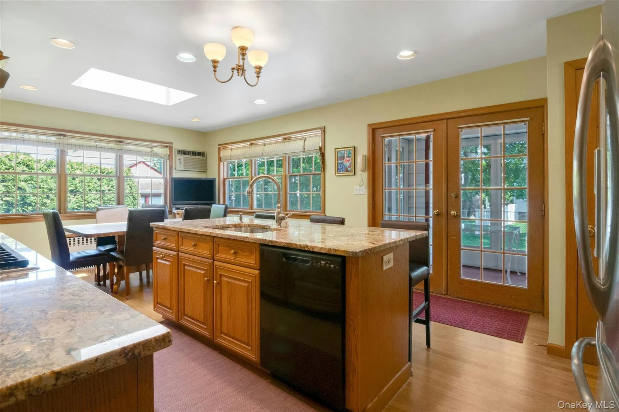 Expanded kitchen opens to screened porch Expanded kitchen opens to screened porch