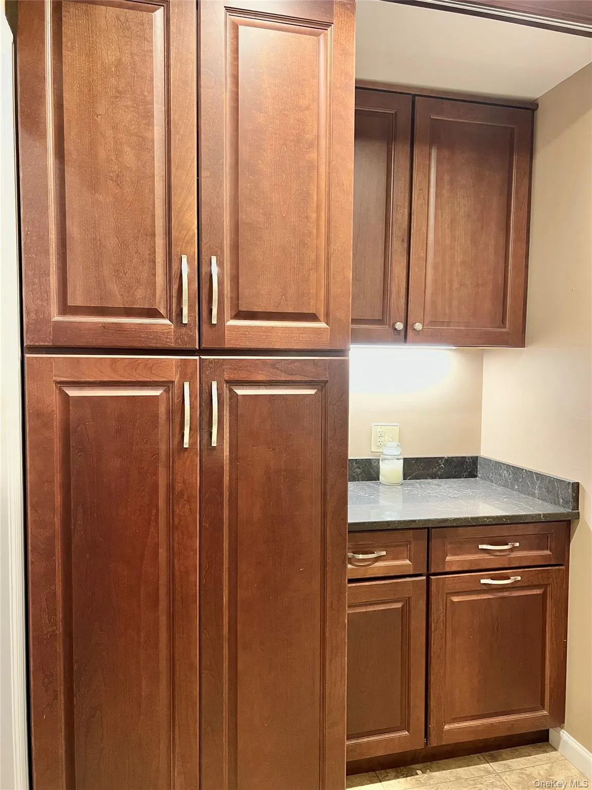 With the sliding door closed. Cabinet space and countertop for folding area. With the sliding door closed. Cabinet space and countertop for folding area.