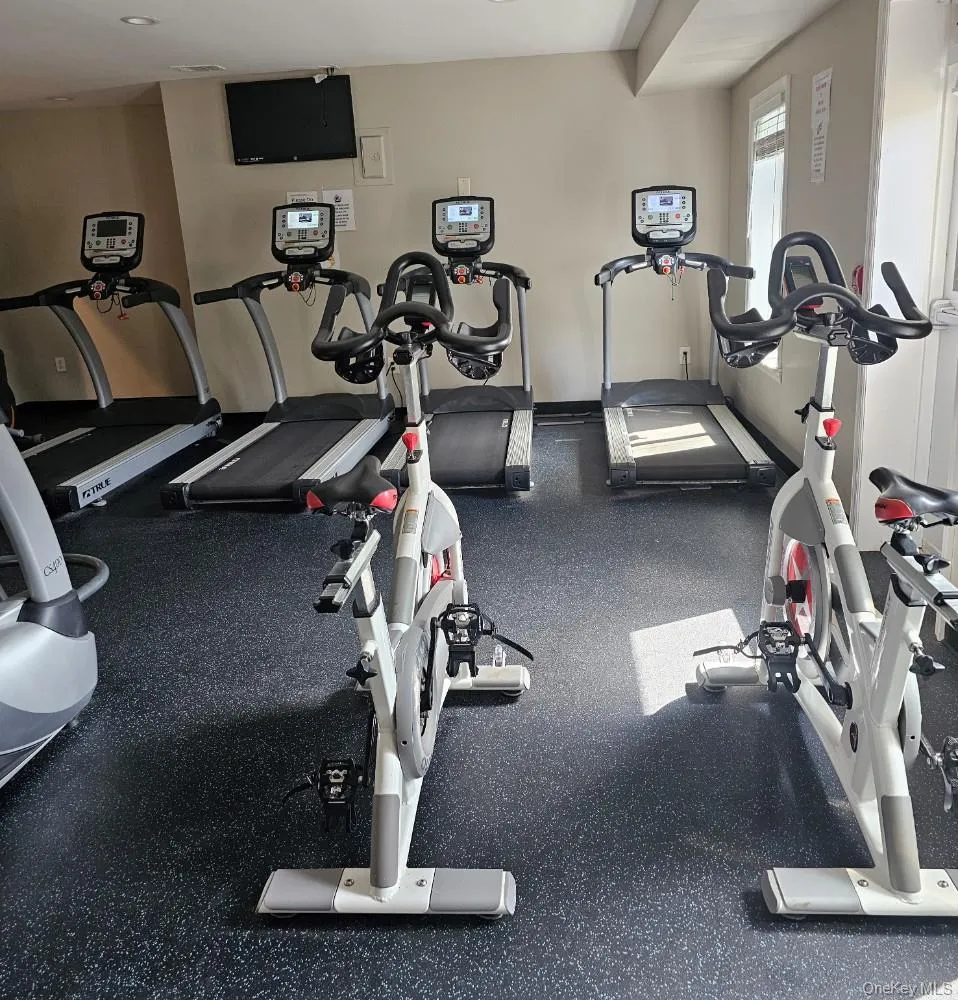 Fitness center featuring specialized flooring and recessed lighting Fitness center featuring specialized flooring and recessed lighting