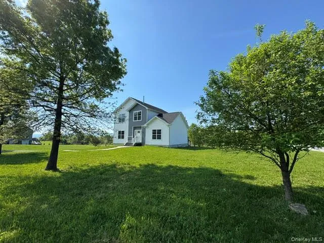 View of the house and front yard from the road. View of the house and front yard from the road.