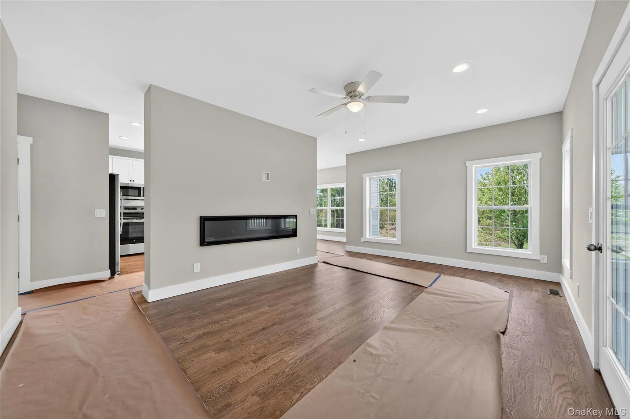 Another view of the open floor plan of the family room with hardwood flooring and the fireplace. Another view of the open floor plan of the family room with hardwood flooring and the fireplace.