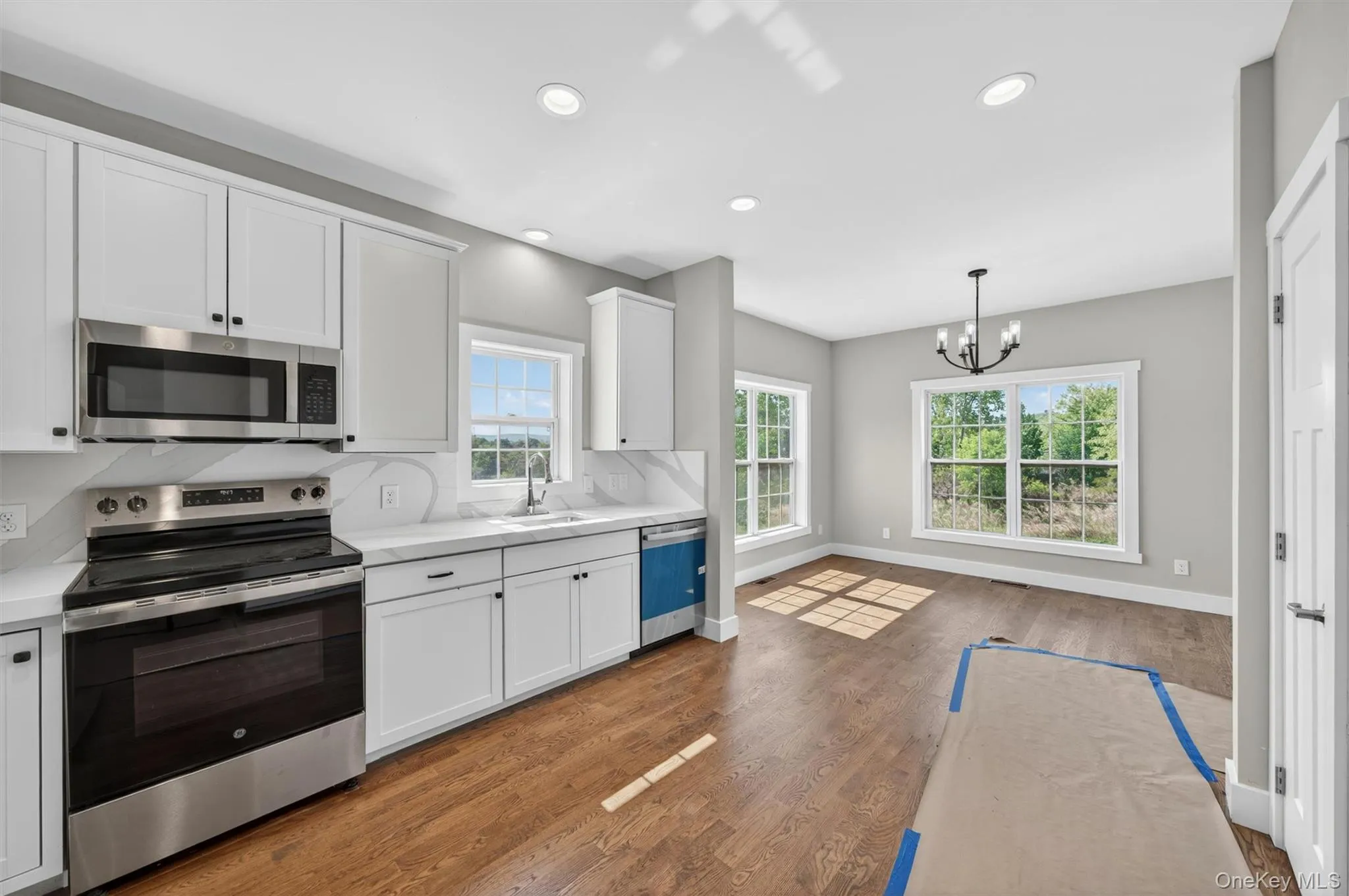 View of the kitchen and breakfast area with hardwood flooring. View of the kitchen and breakfast area with hardwood flooring.