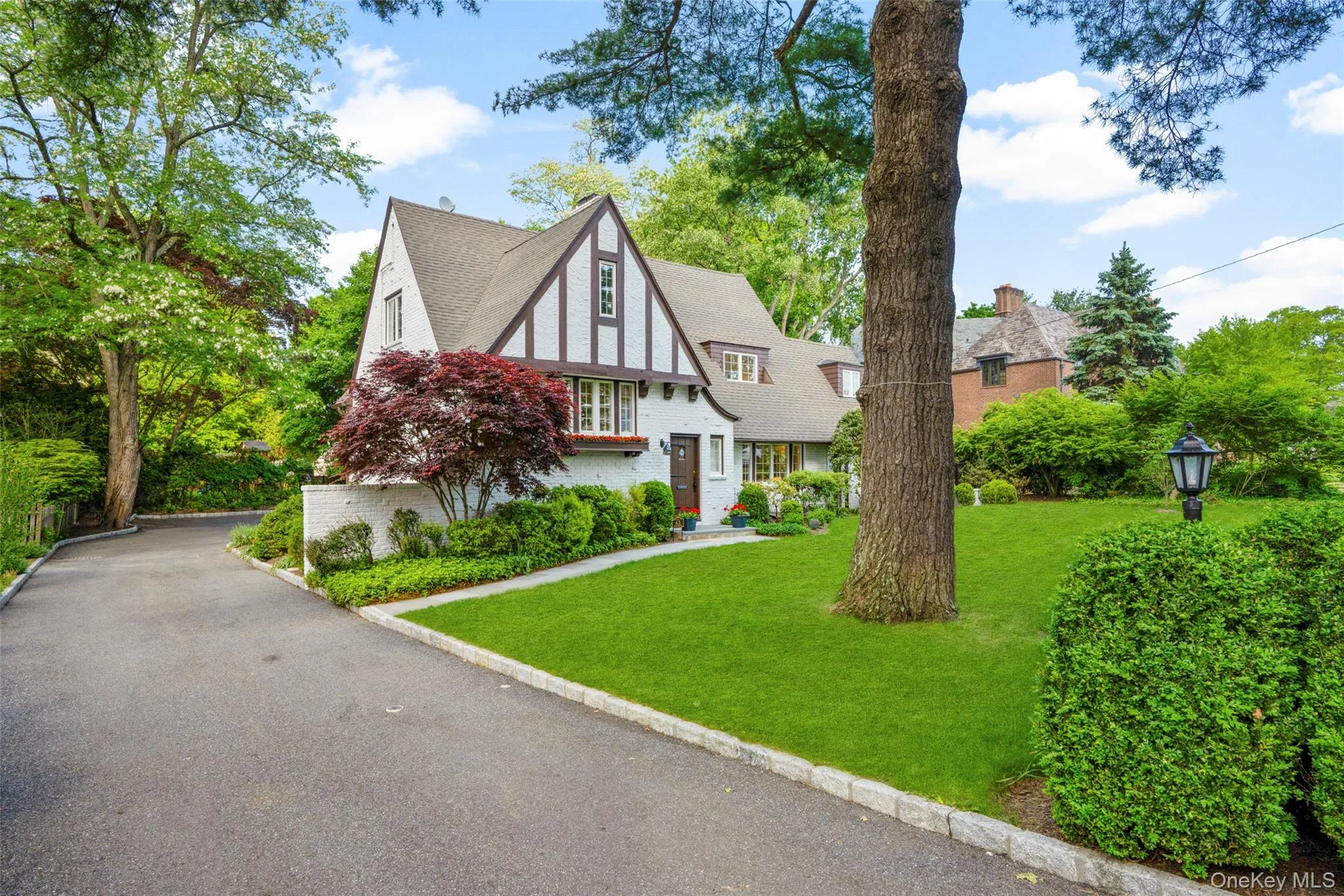 Long driveway leads to a tandem two-garage tucked behind the home. Long driveway leads to a tandem two-garage tucked behind the home.