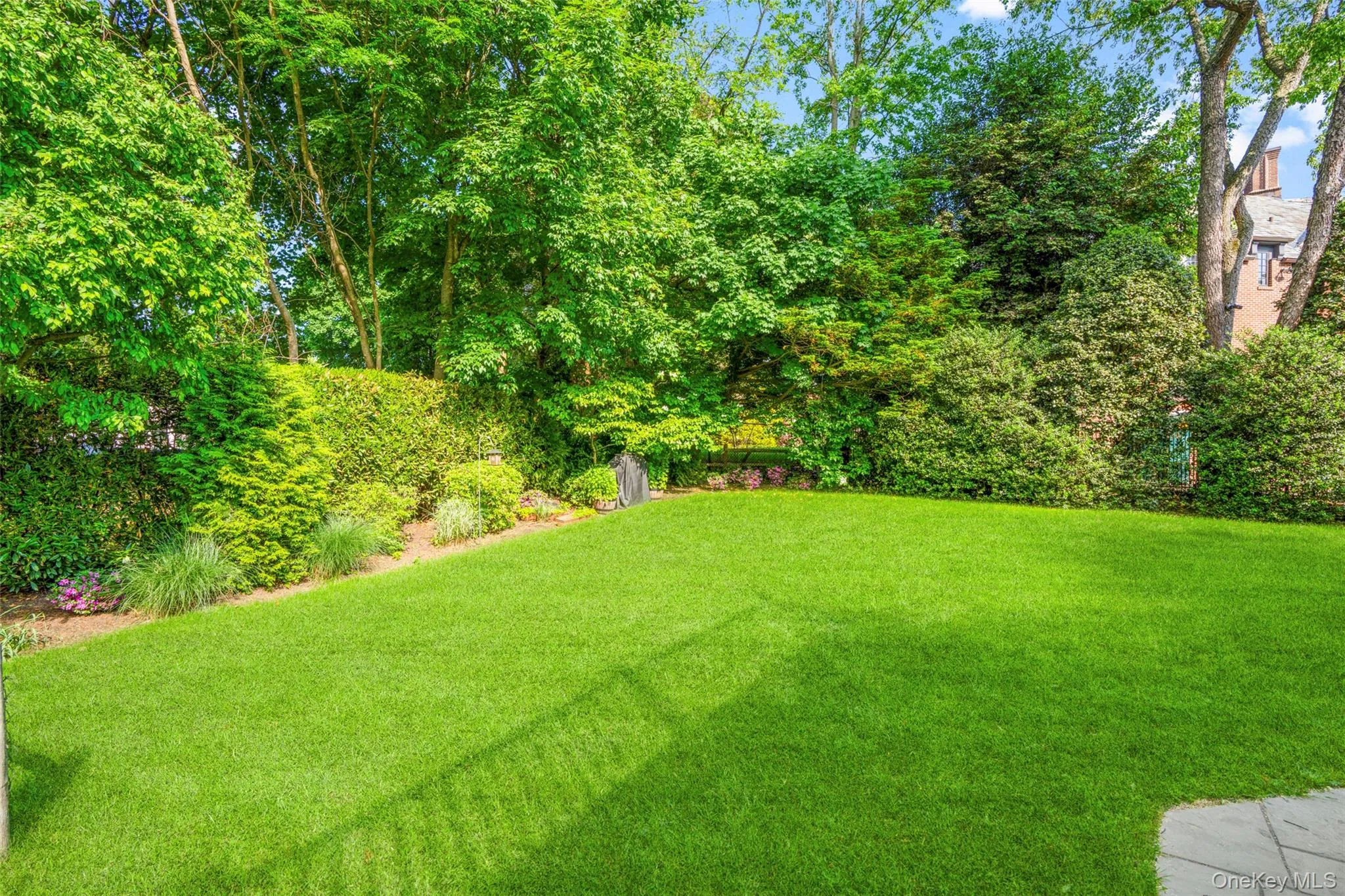 Expansive grassy area bordered by manicured hedges. Expansive grassy area bordered by manicured hedges.
