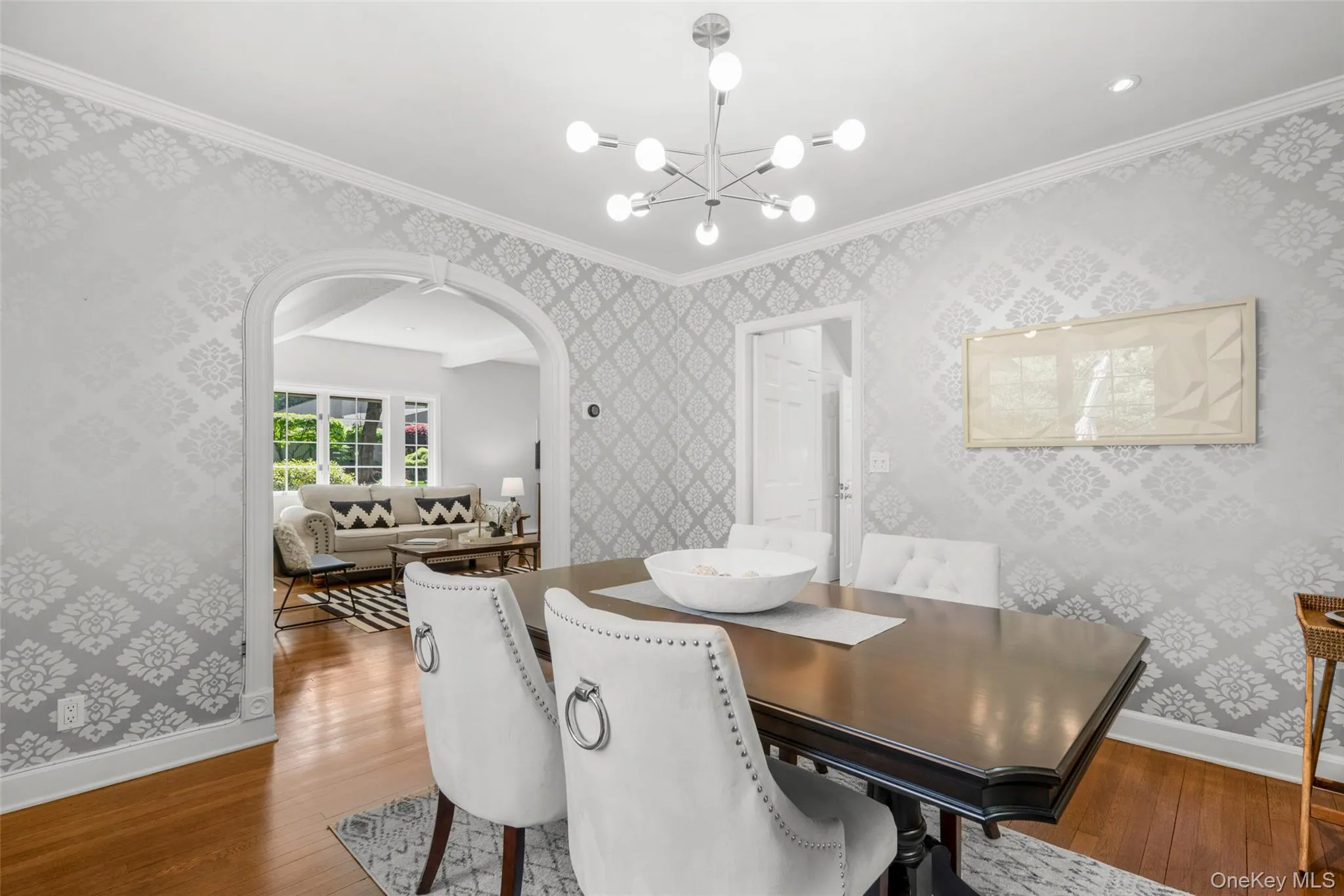 Formal dining room with elegant arched opening and seamless flow to through the butler's door. Formal dining room with elegant arched opening and seamless flow to through the butler's door.