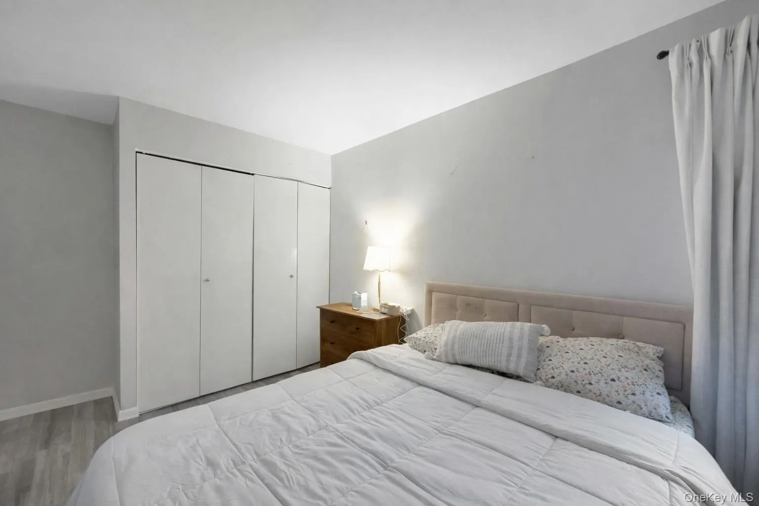 Bedroom with wood finished floors and a closet Bedroom with wood finished floors and a closet