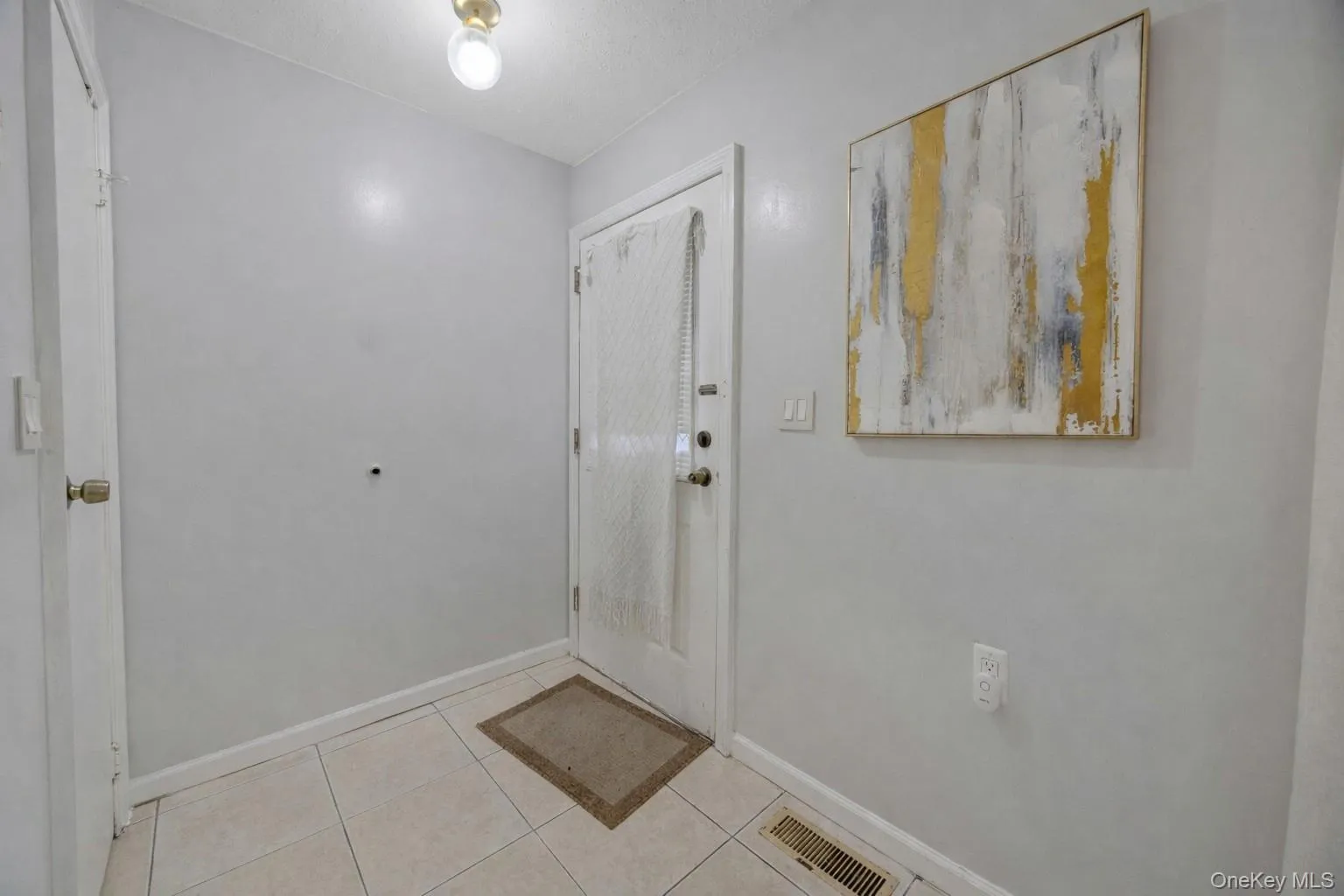 Foyer with baseboards and light tile patterned floors Foyer with baseboards and light tile patterned floors