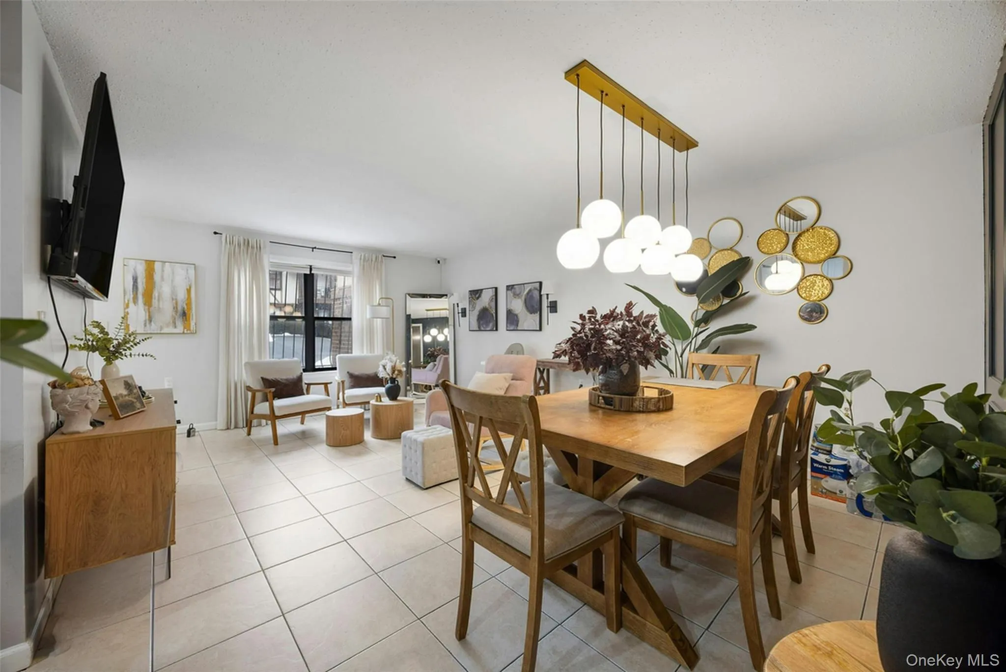 Dining room featuring light tile patterned floors and a chandelier Dining room featuring light tile patterned floors and a chandelier