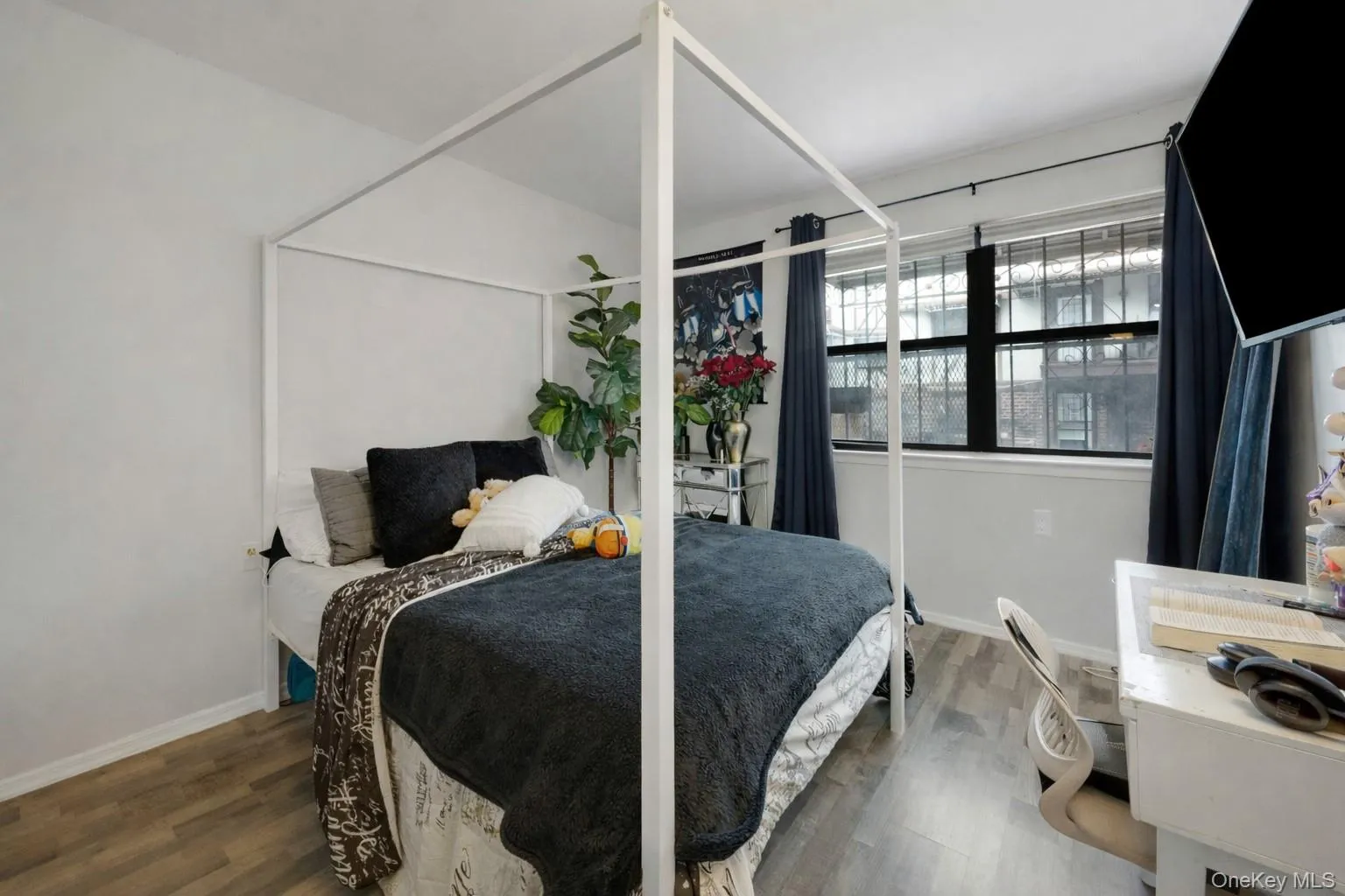 Bedroom with wood finished floors and baseboards Bedroom with wood finished floors and baseboards