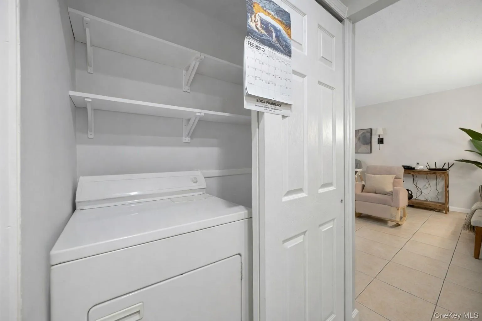 Laundry area featuring light tile patterned floors Laundry area featuring light tile patterned floors