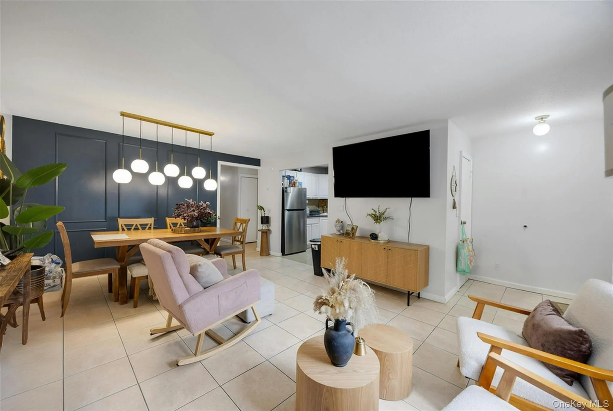 Living area featuring light tile patterned floors and baseboards Living area featuring light tile patterned floors and baseboards