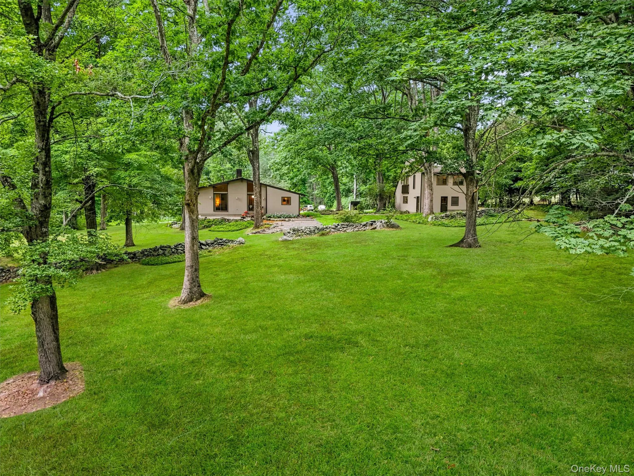 Expansive green lawn with mature trees Expansive green lawn with mature trees