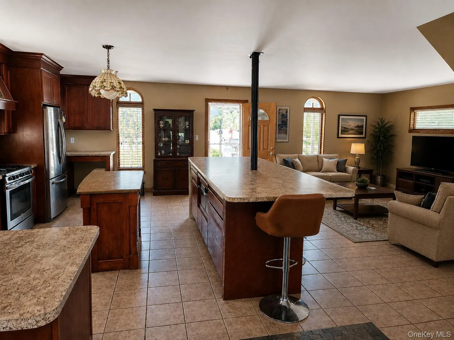 Virtually staged photo to show a living room space replacing the existing dining room space Virtually staged photo to show a living room space replacing the existing dining room space