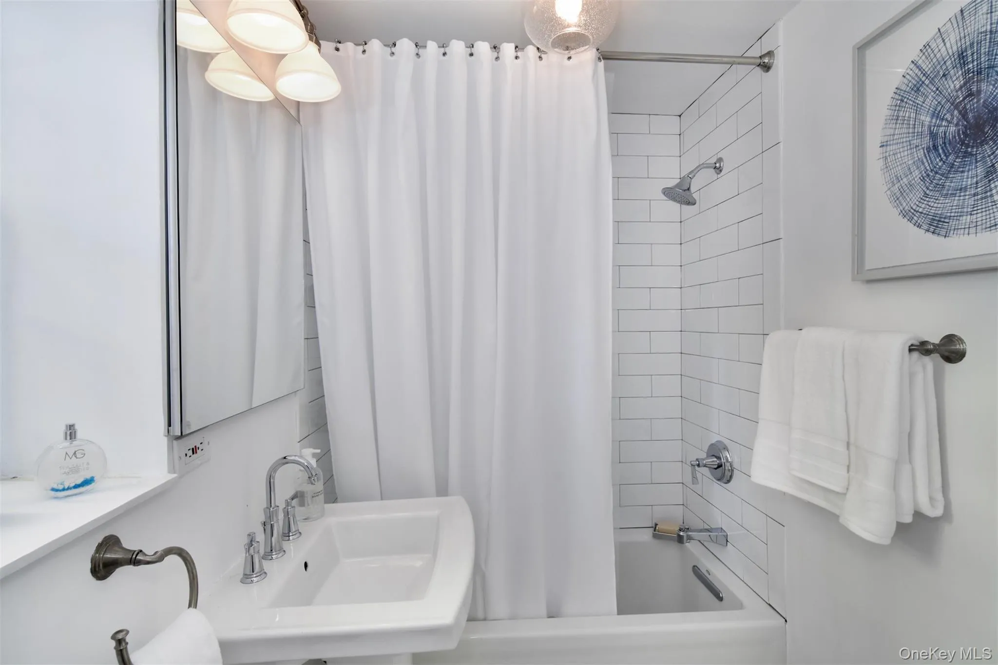 Custom en-suite bathroom with window, stainless steel fixtures, & architectural lighting. Custom en-suite bathroom with window, stainless steel fixtures, & architectural lighting.