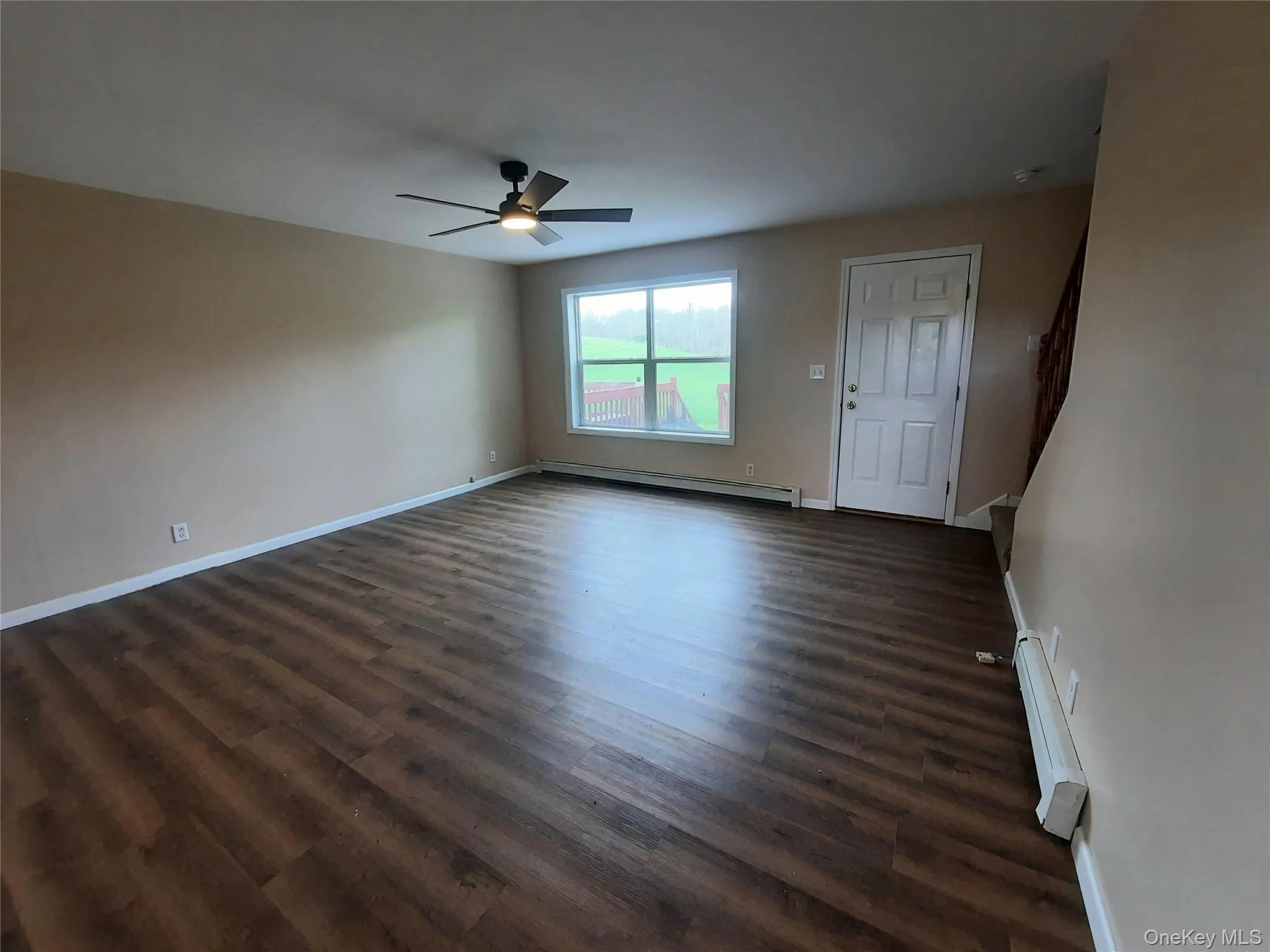 The living room has a back door out to the deck. The living room has a back door out to the deck.