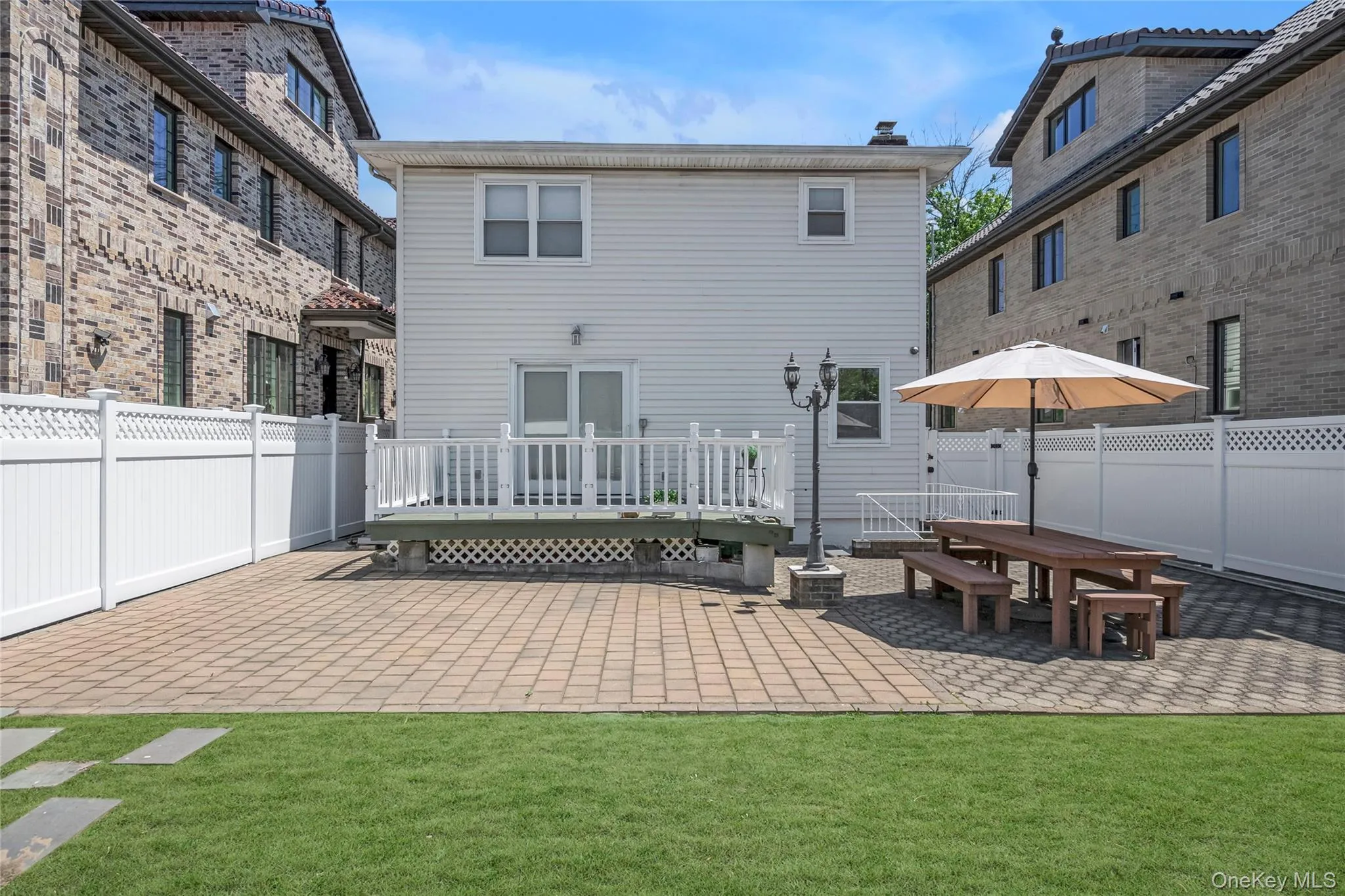 Brick paved patio qnd grass in the backyard Brick paved patio qnd grass in the backyard