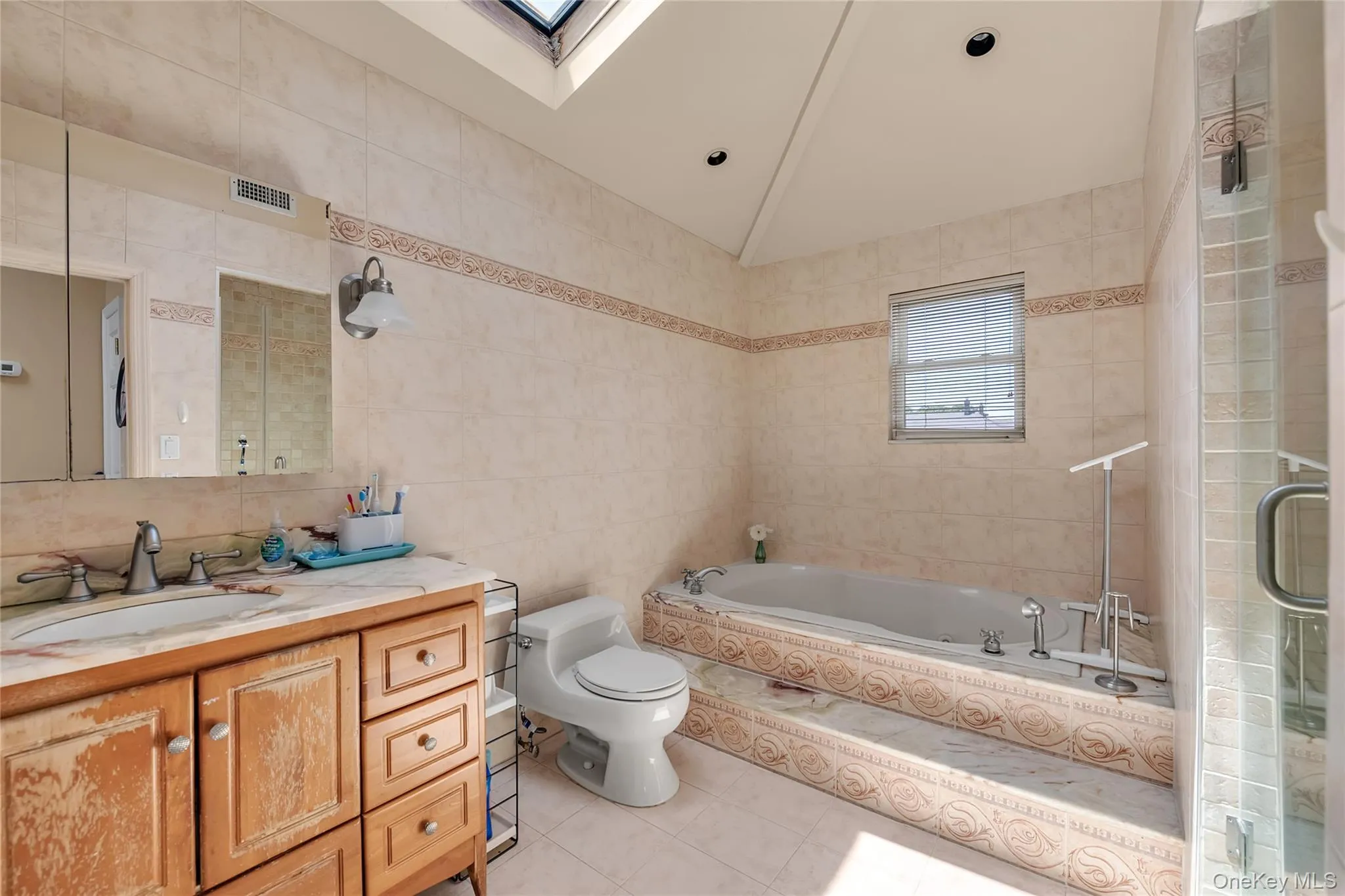 Luxurious primary bathroom on the 2nd floor, full size jacuzzi bathtub and a shower bathroom, skylight in the soaring ceiling for nature sunlight Luxurious primary bathroom on the 2nd floor, full size jacuzzi bathtub and a shower bathroom, skylight in the soaring ceiling for nature sunlight