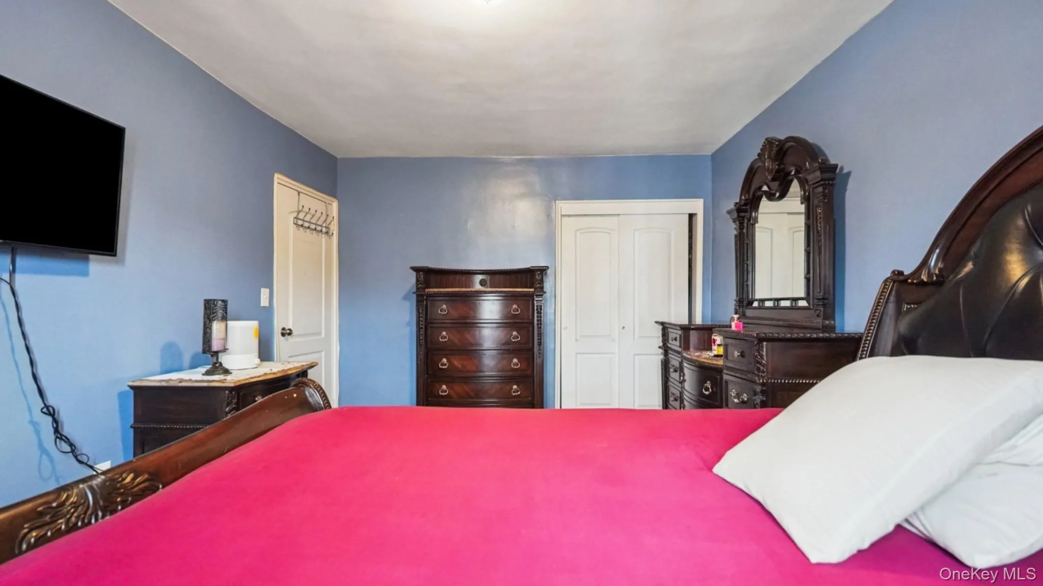 Spacious room featuring light blue walls and a white ceiling Spacious room featuring light blue walls and a white ceiling