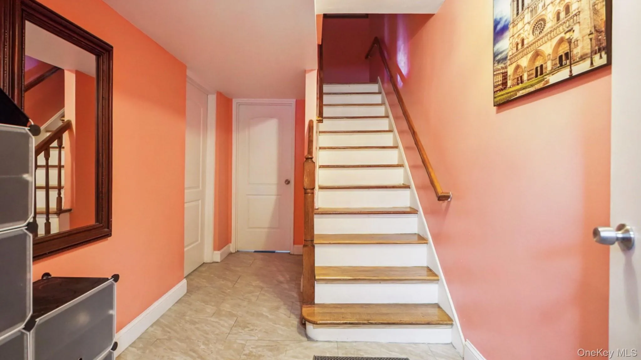 Wood-finish staircase with white risers and a light wood handrail Wood-finish staircase with white risers and a light wood handrail