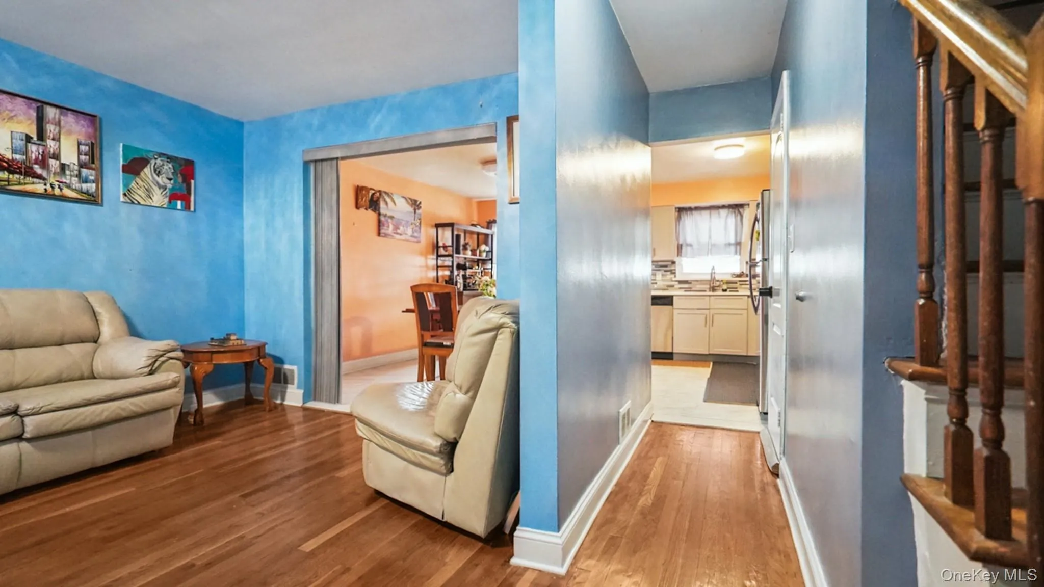 Hardwood flooring extending throughout the living space and hallway Hardwood flooring extending throughout the living space and hallway