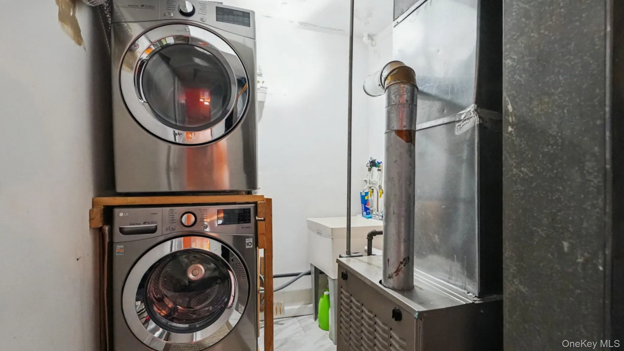 Dedicated laundry area featuring stacked front-loading washer and dryer units Dedicated laundry area featuring stacked front-loading washer and dryer units