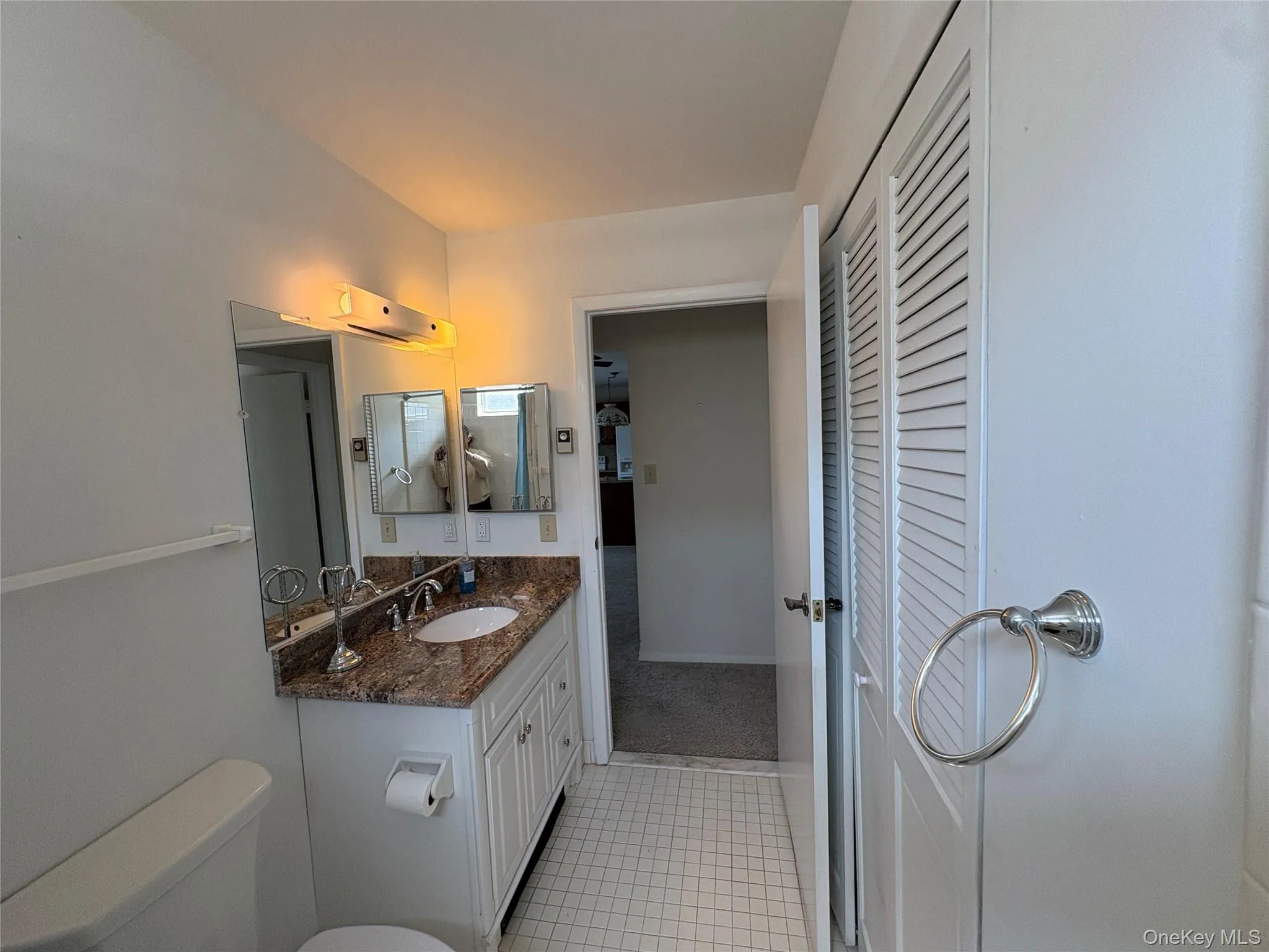 Bathroom with granite vanity, tub/shower combo and washer/dryer behing the bifold doors. Bathroom with granite vanity, tub/shower combo and washer/dryer behing the bifold doors.