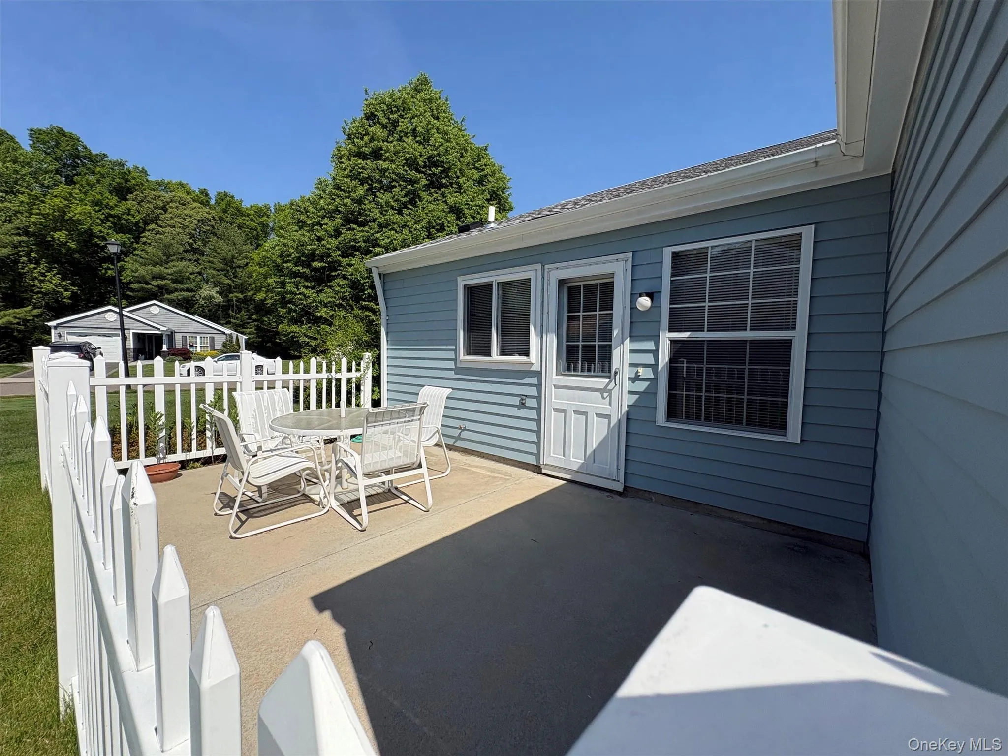 Welcome to your backyard patio, picket fence and all. Welcome to your backyard patio, picket fence and all.