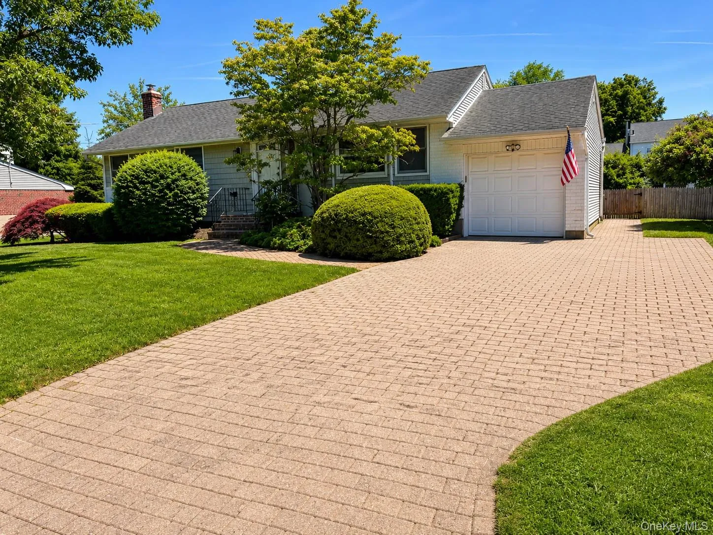 Charming single-story residence featuring light-colored siding and a dark shingle roof Charming single-story residence featuring light-colored siding and a dark shingle roof