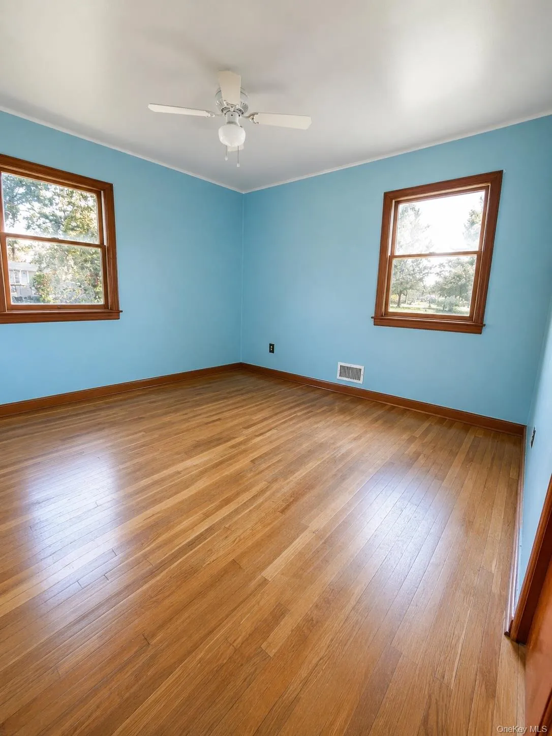 Primary bedroom with hardwood flooring. Primary bedroom with hardwood flooring.