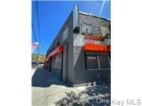 Property Listing Photo. Exterior perspective of the commercial building with awnings and signage Property Listing Photo. Exterior perspective of the commercial building with awnings and signage