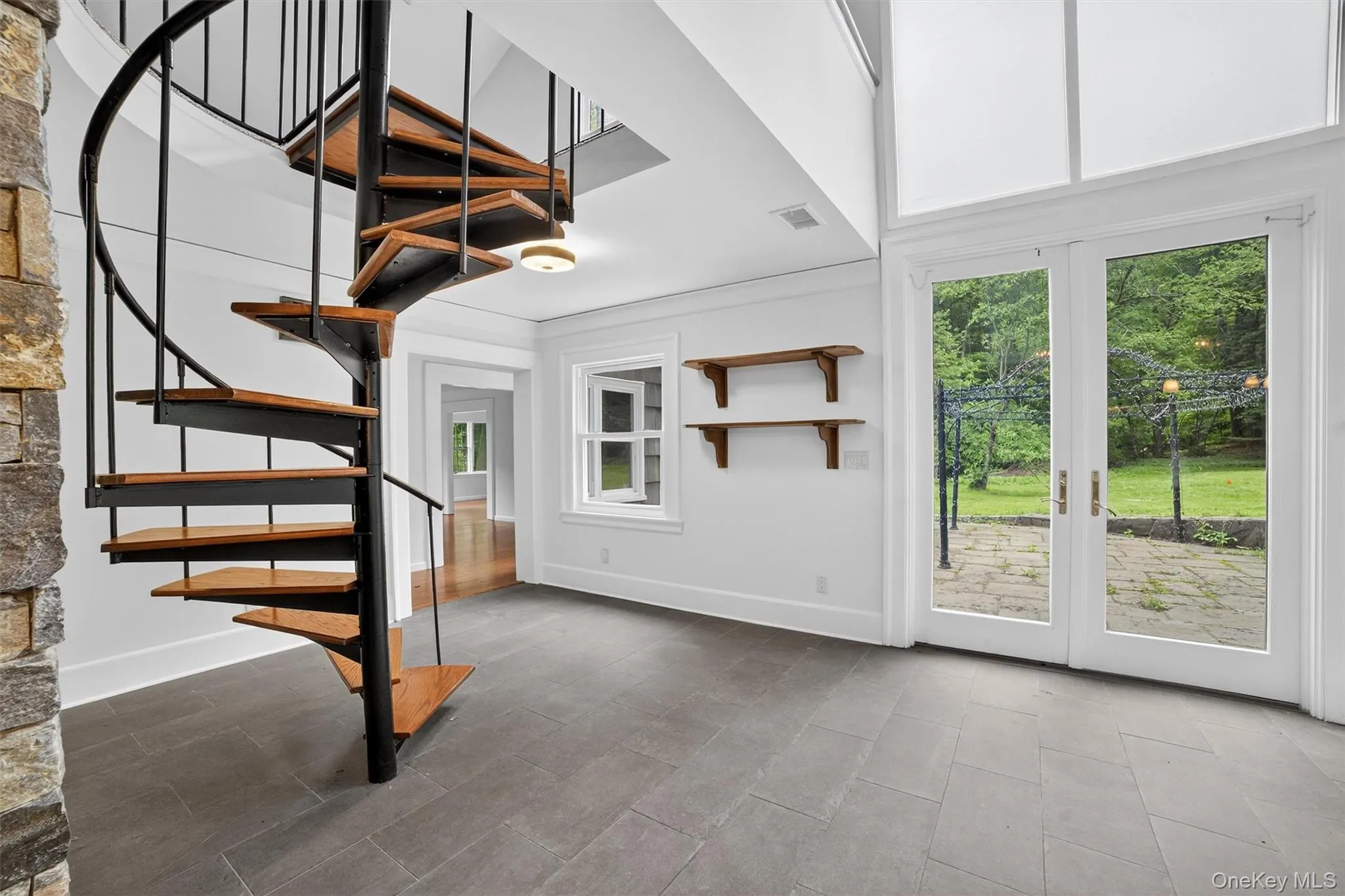 Stairs featuring plenty of natural light and a high ceiling Stairs featuring plenty of natural light and a high ceiling
