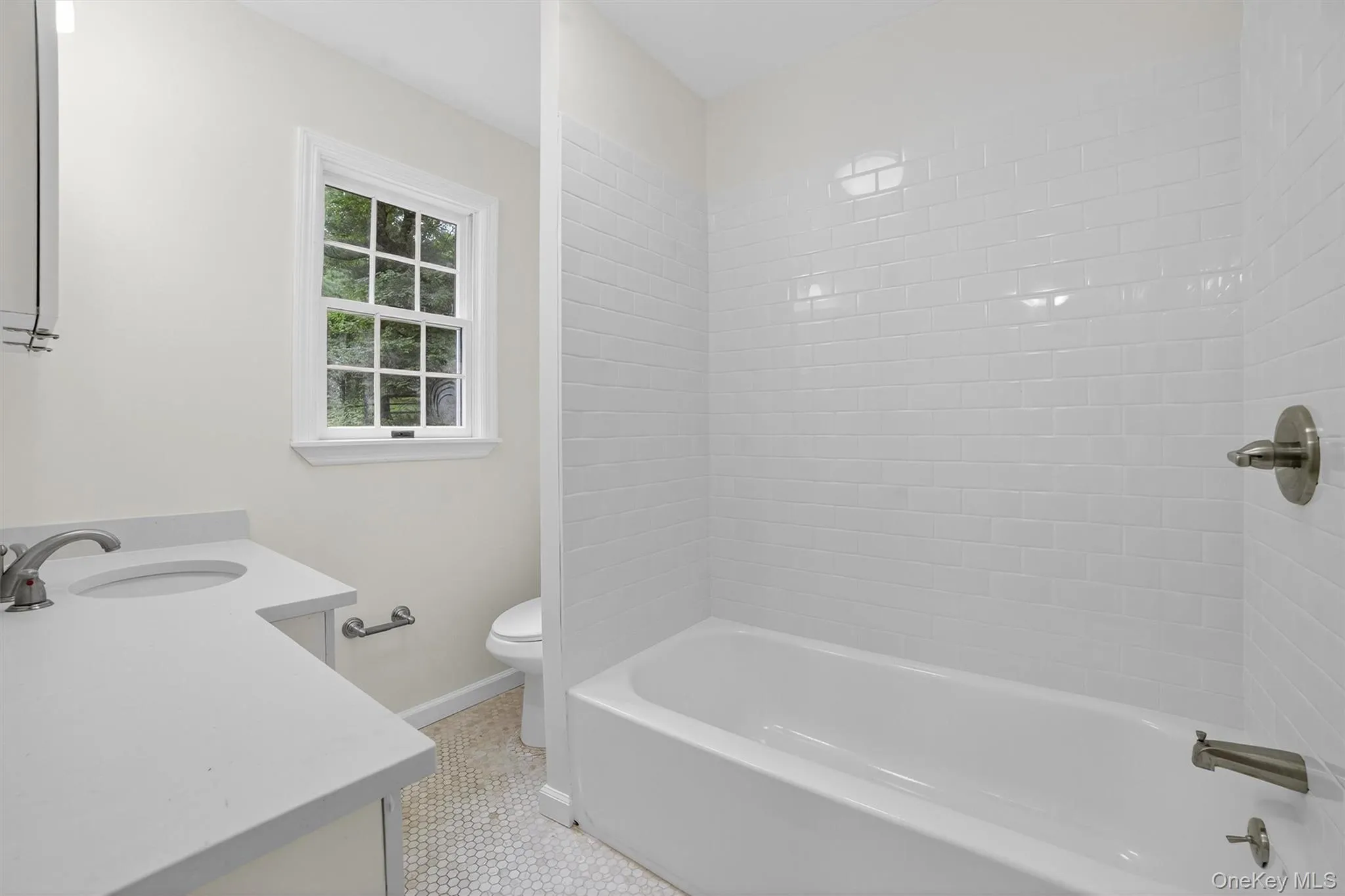 Bathroom with vanity, bathtub / shower combination, and tile patterned flooring Bathroom with vanity, bathtub / shower combination, and tile patterned flooring