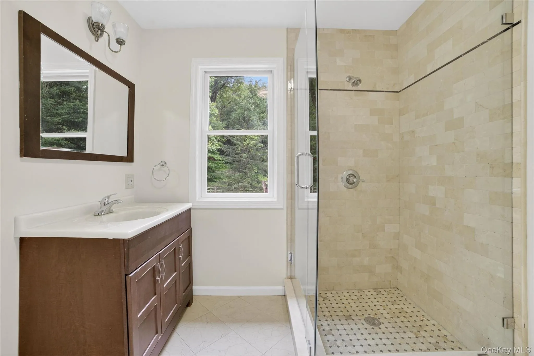 Full bathroom featuring a shower stall and vanity Full bathroom featuring a shower stall and vanity