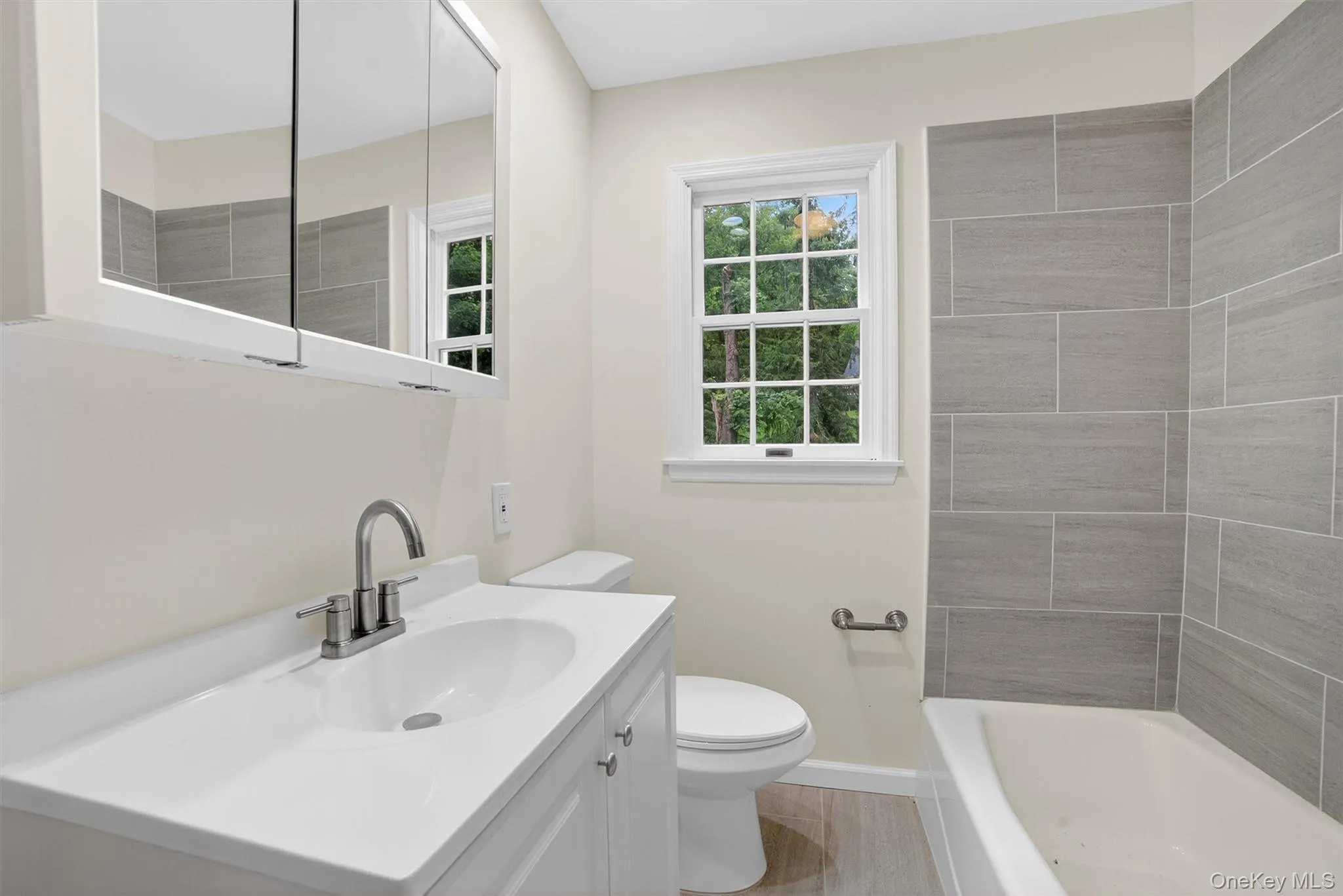 Bathroom featuring toilet and vanity Bathroom featuring toilet and vanity
