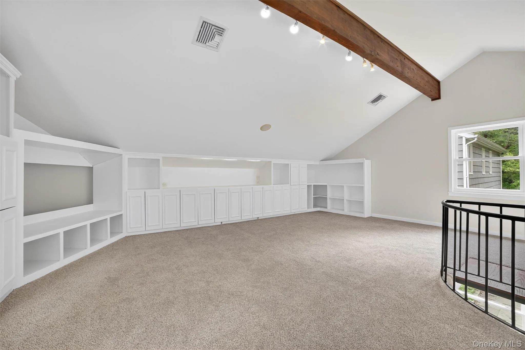 Bonus room with carpet and built in features Bonus room with carpet and built in features