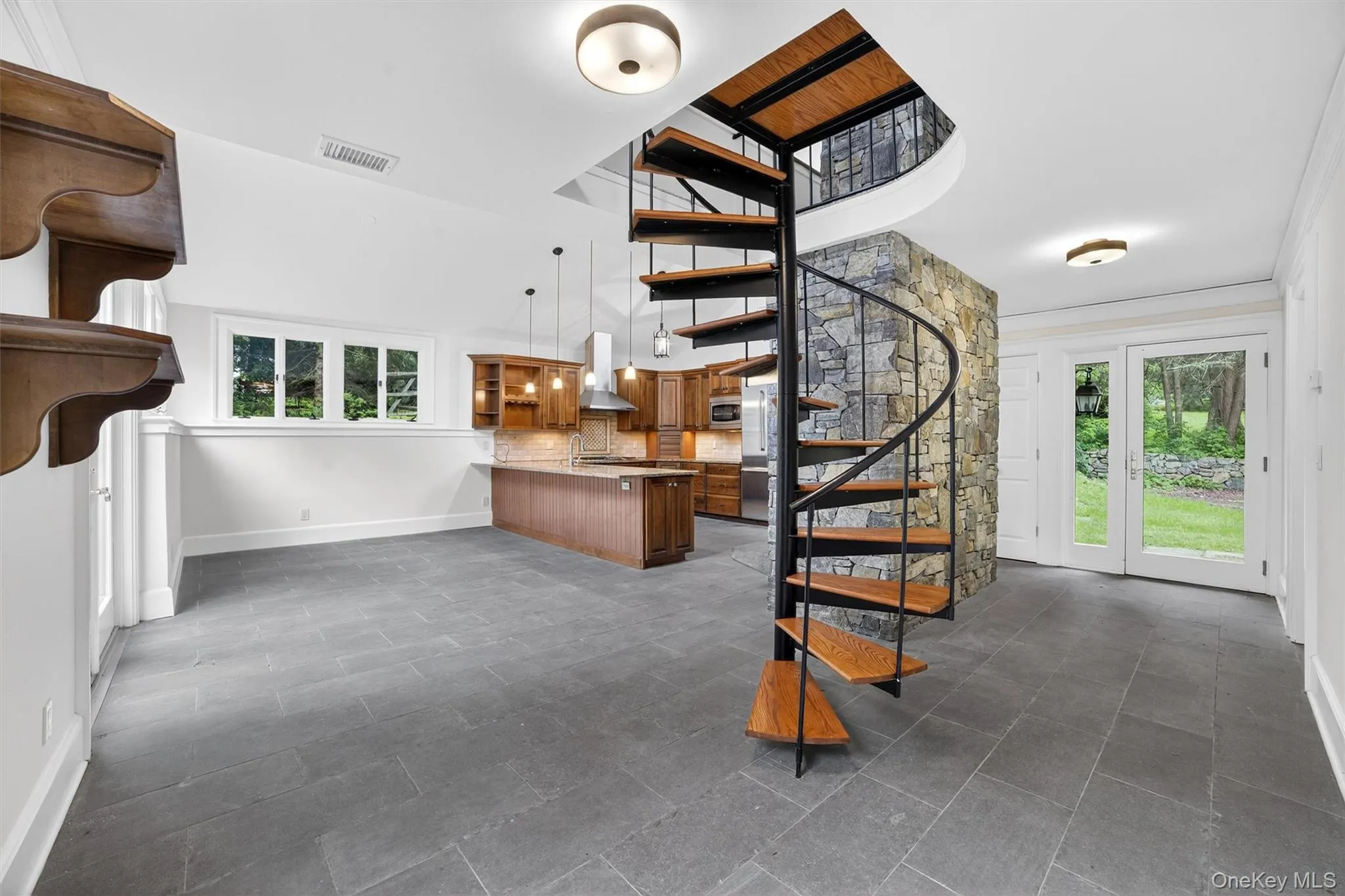 Stairs featuring healthy amount of natural light and a high ceiling Stairs featuring healthy amount of natural light and a high ceiling